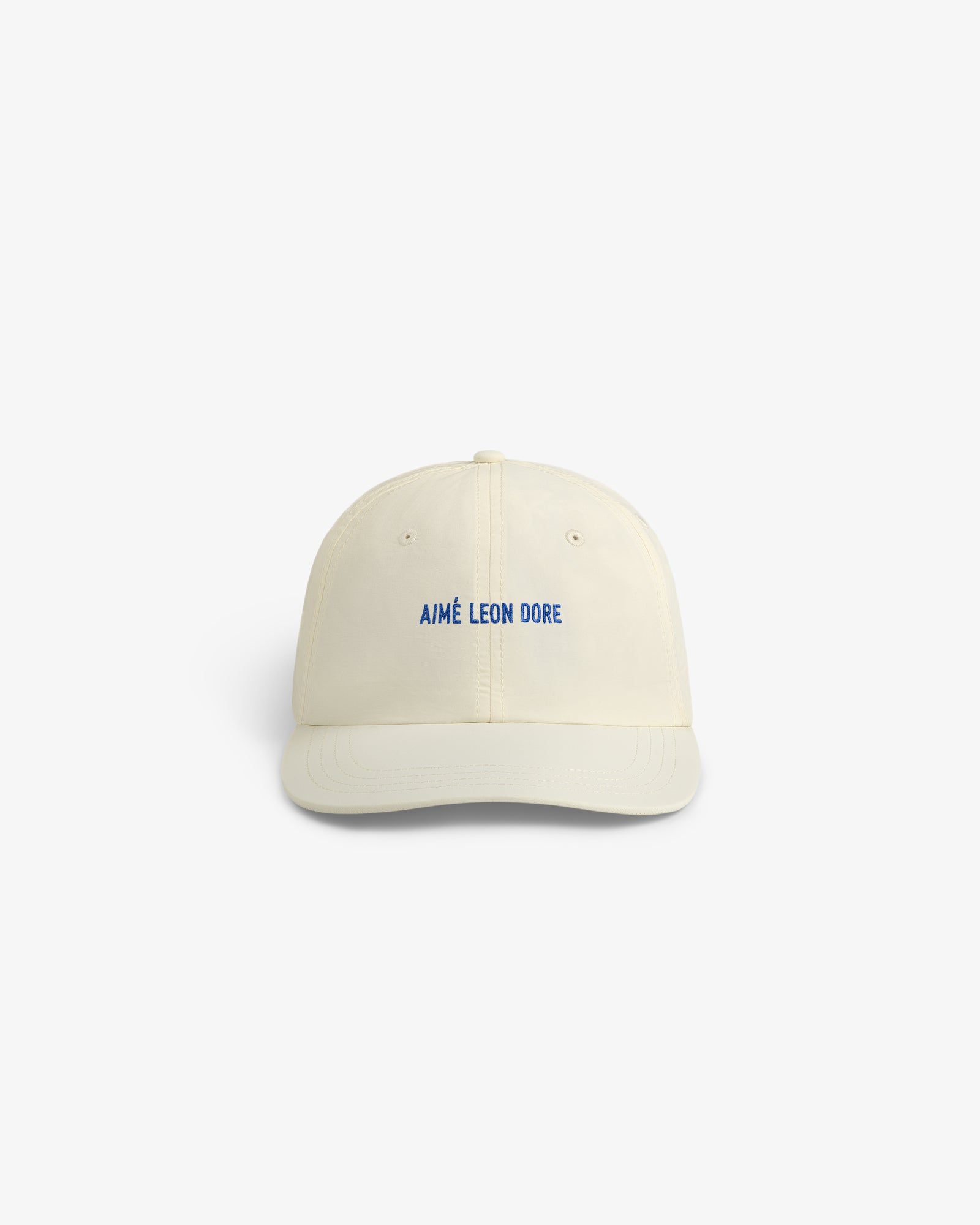 Cream-colored Nylon Sport Hat with AIMÉ LEON DORE embroidered in blue, shown against a white background.