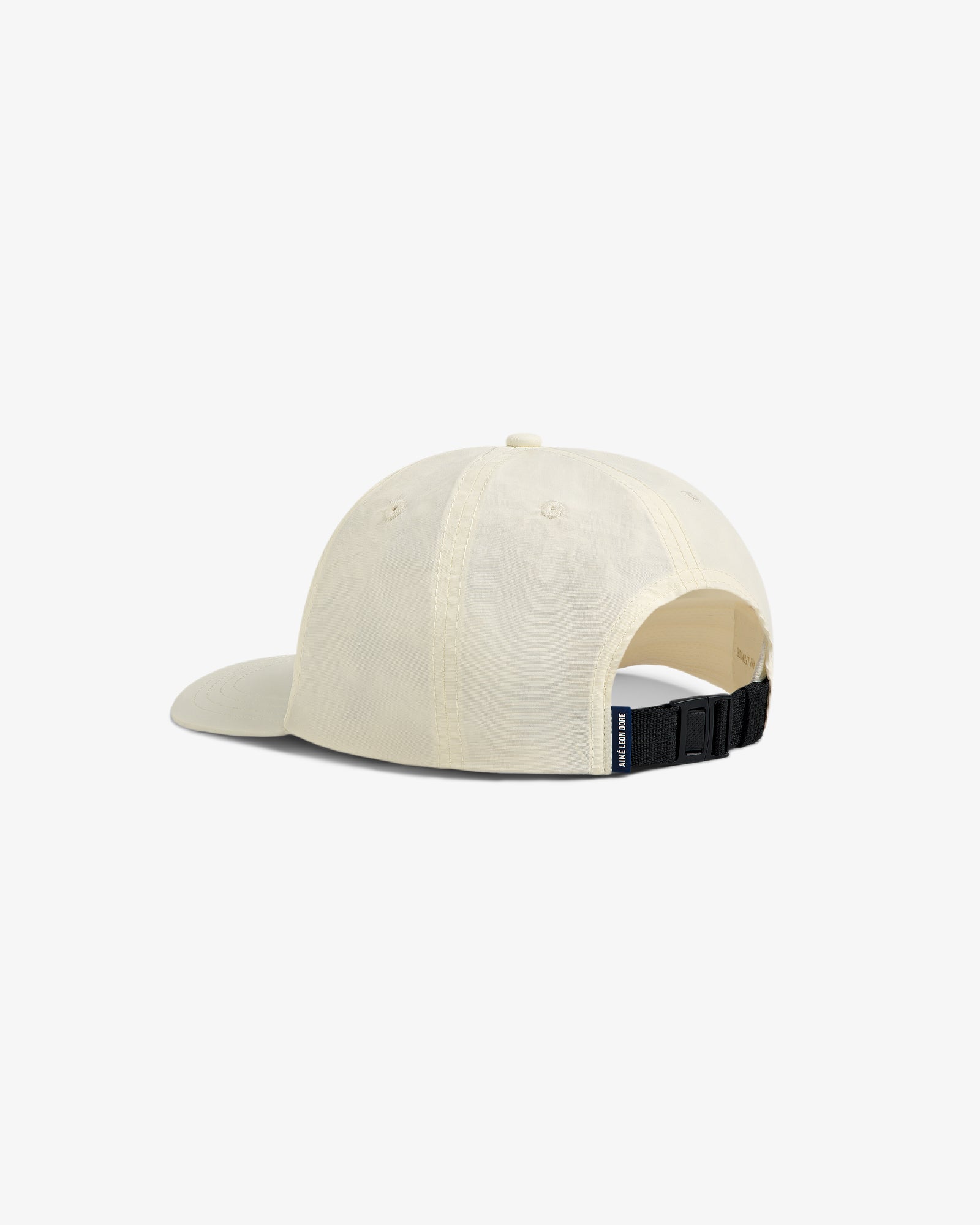 A cream Nylon Sport Hat shown from the back with an adjustable black strap and a small fabric tag.