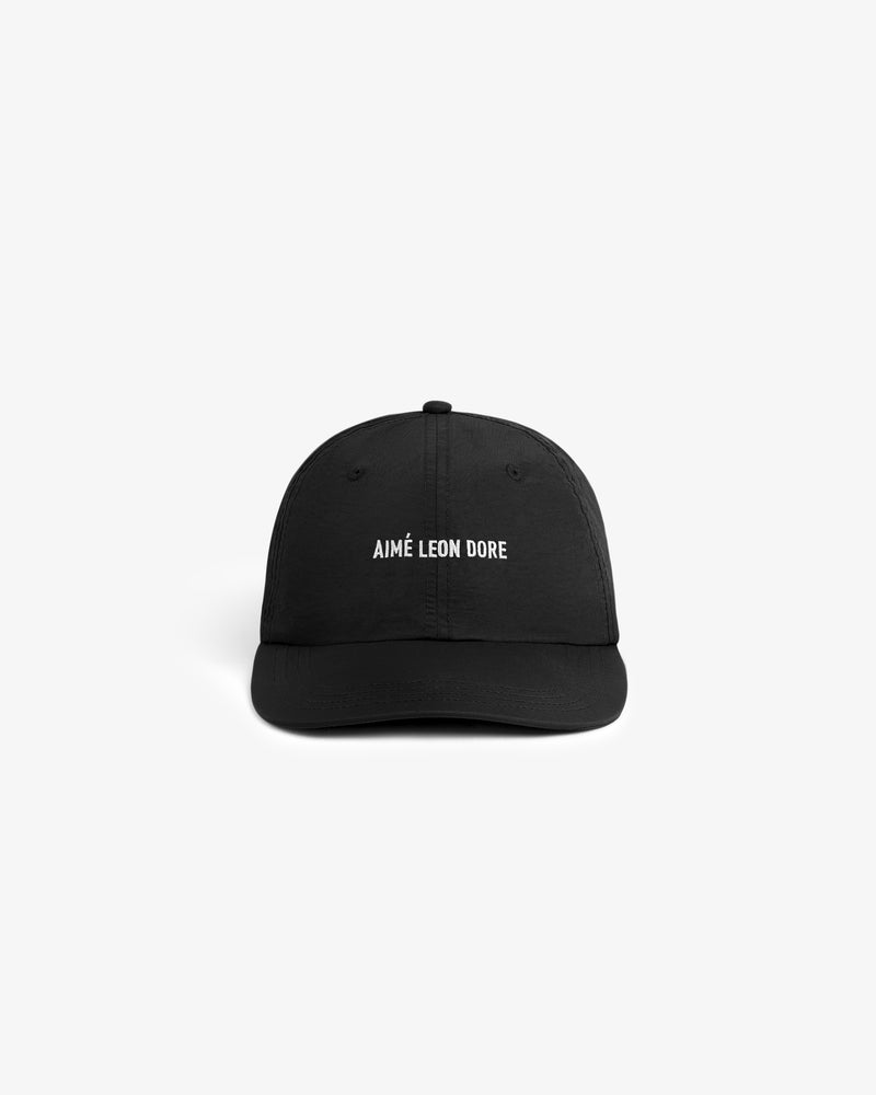 Black Nylon Sport Hat with AIMÉ LEON DORE in white text on the front, shown on a plain white background.