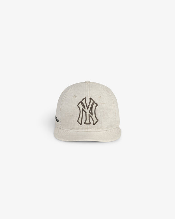 ALD / New York Yankees Retro Fit Hat in beige with a black logo, shown on a plain white background.