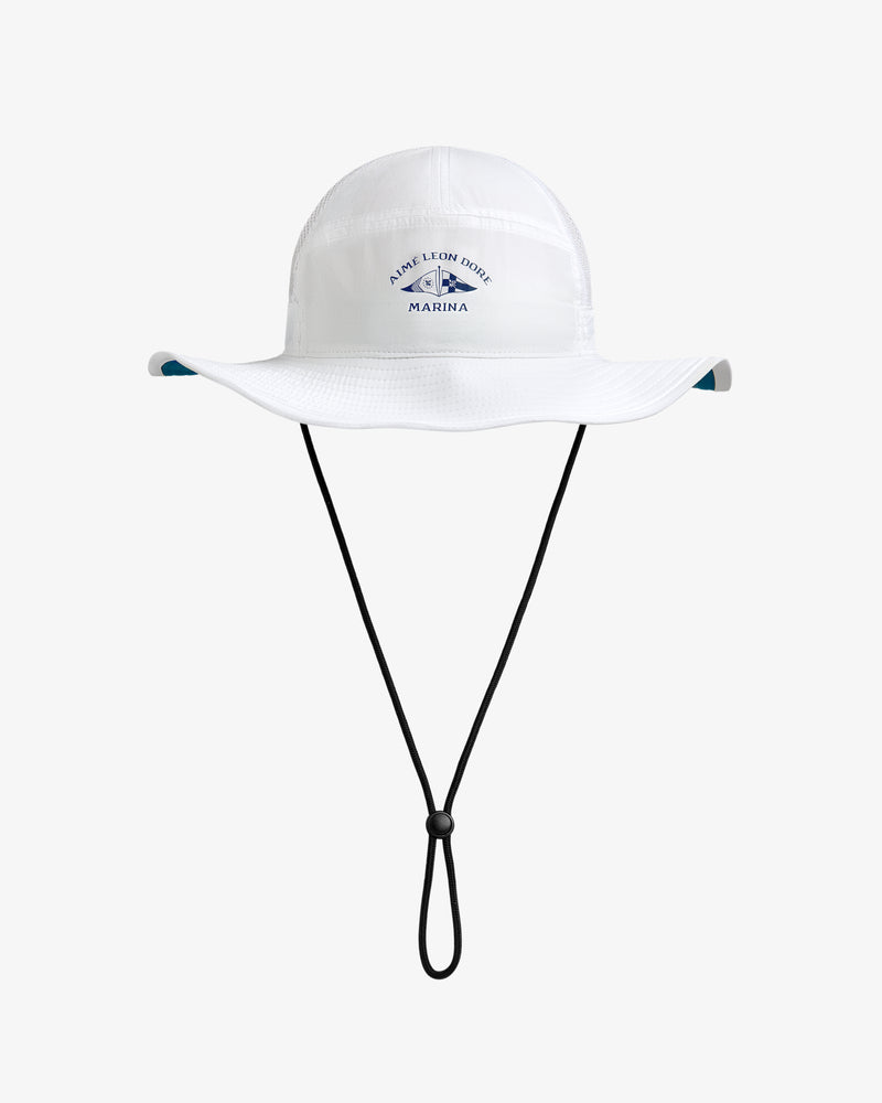 Marina Boonie Bucket Hat: white, wide-brim with chin strap and blue Marina logo on front, shown on plain background.