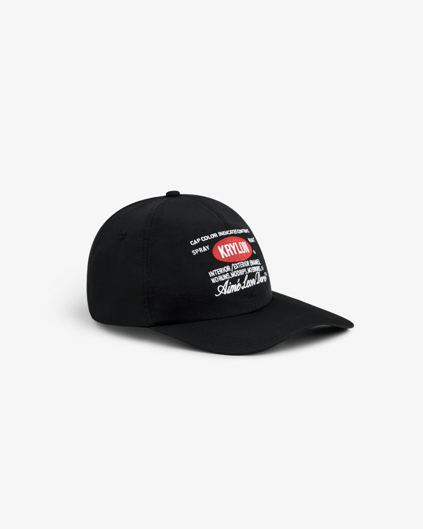 Krylon Label Hat: black baseball cap with white and red embroidered text, shown on a white background.