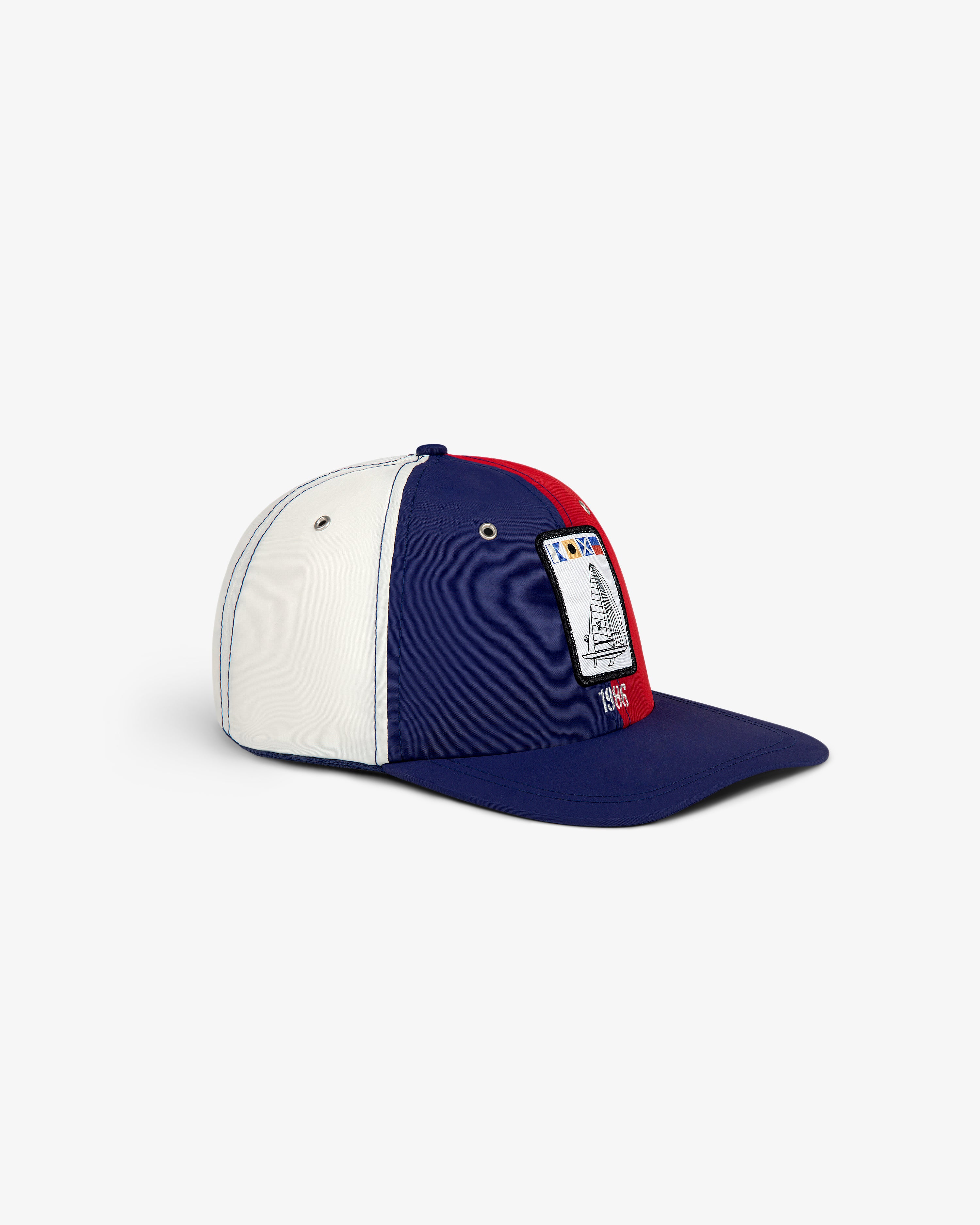 Nylon Deck Hat in blue, white, and red with sailboat patch and "1985" on the front.