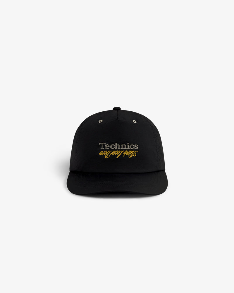 ALD / Technics Nylon Logo Hat with silver Technics and gold definitive dna script on front, shown on white background.
