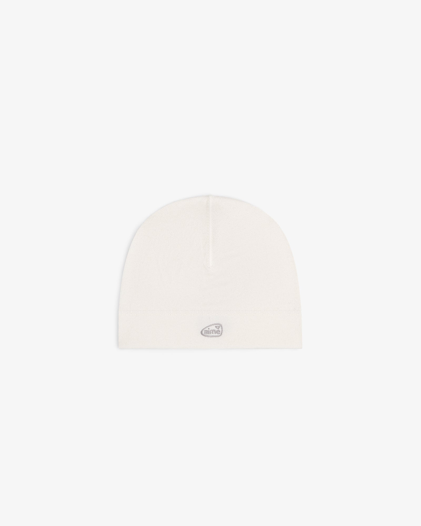 ALD Golf Skull Cap in off-white with a small oval silver logo patch on the front, shown on a white background.