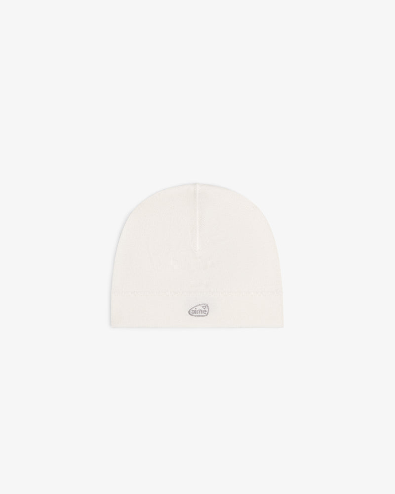 ALD Golf Skull Cap in off-white with a small oval silver logo patch on the front, shown on a white background.