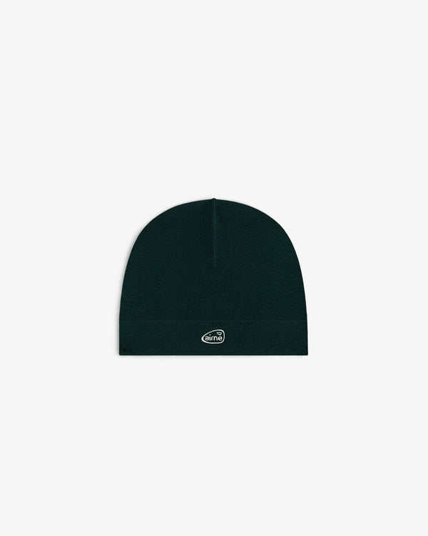 ALD Golf Skull Cap—black knit beanie with small white oval logo patch, shown on plain white background.
