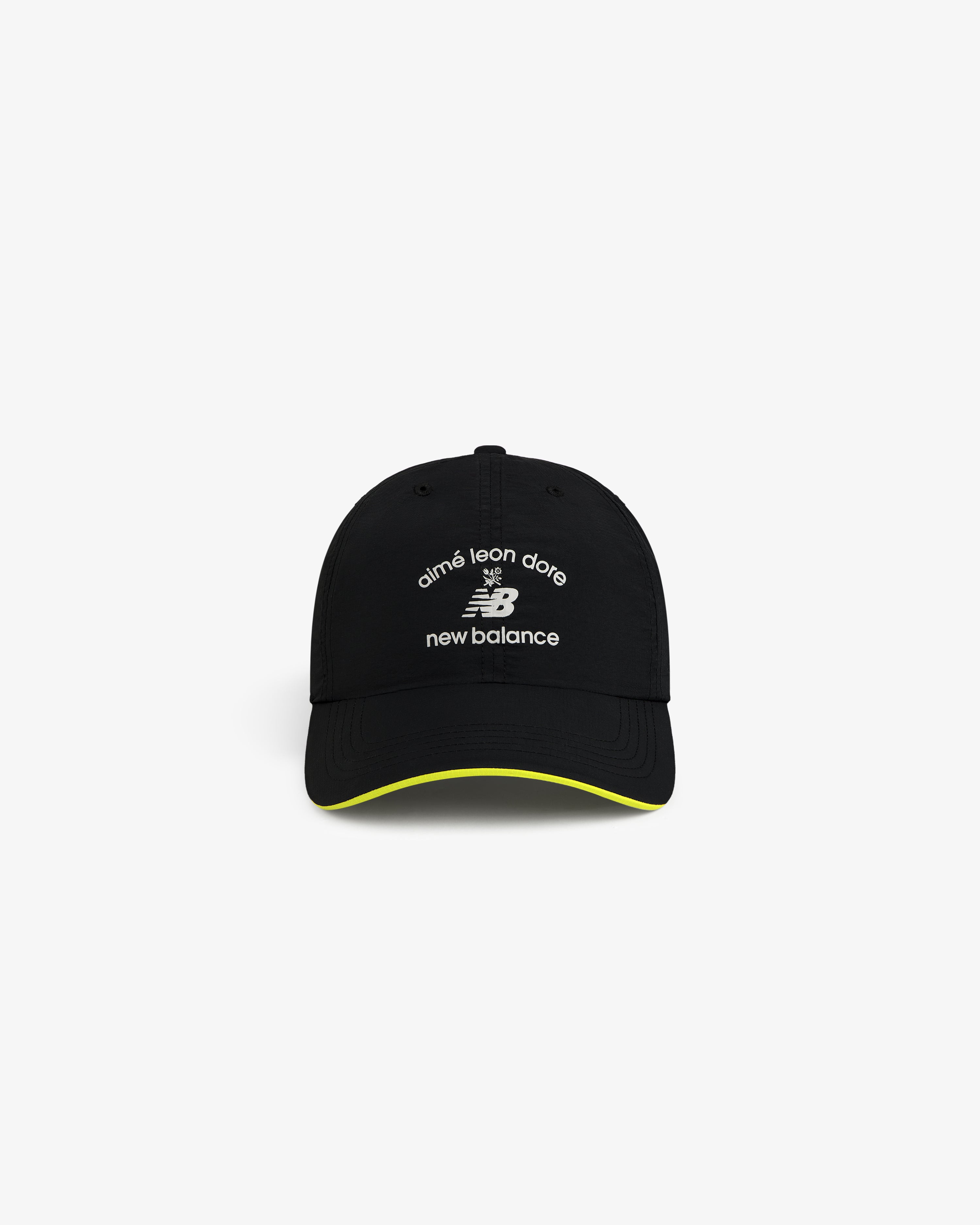 ALD / New Balance Running Hat: black cap with white logos, yellow trim on brim, shown on white background.
