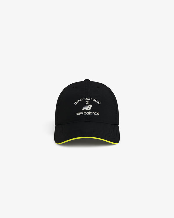 ALD / New Balance Running Hat: black cap with white logos, yellow trim on brim, shown on white background.