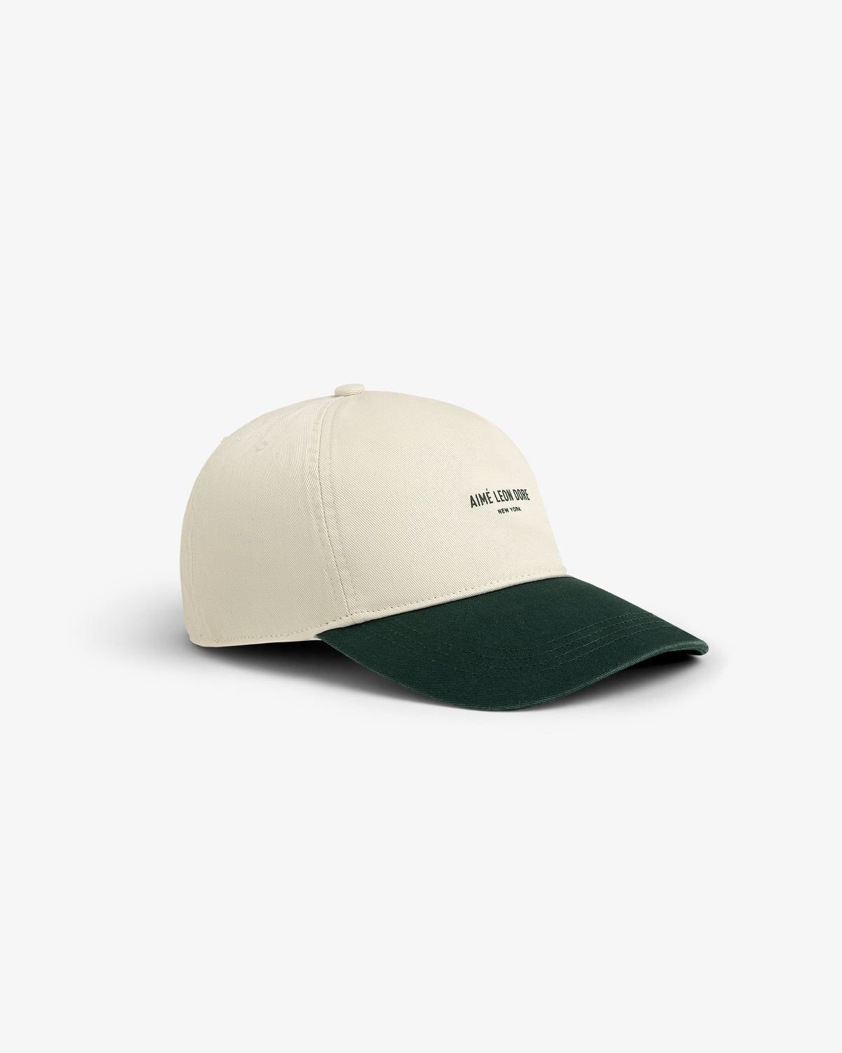 Micro Logo Hat in beige with a dark green brim and small front text, displayed on a white background.