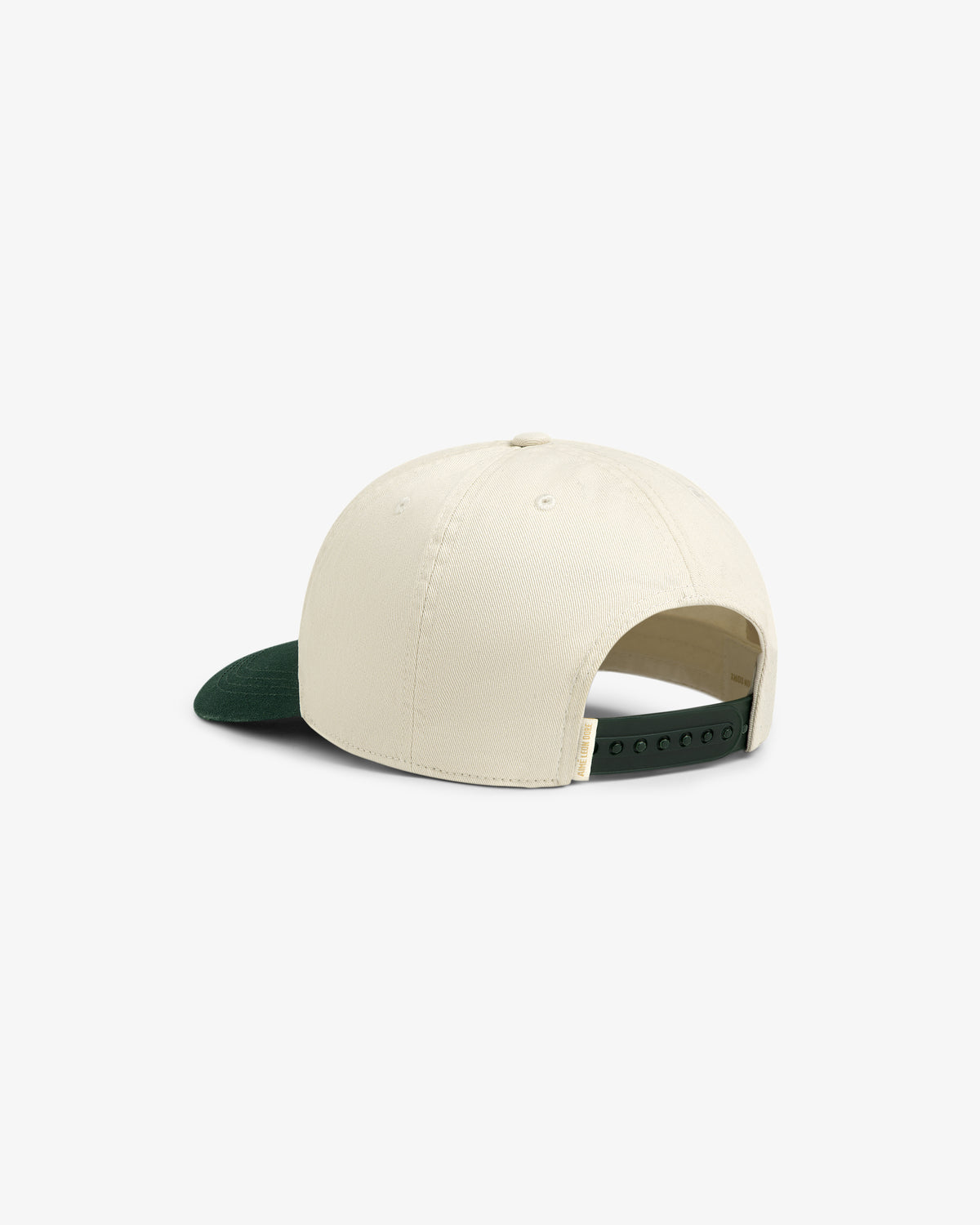 The Micro Logo Hat is cream-colored with a dark green brim, shown from the back with an adjustable snap closure.