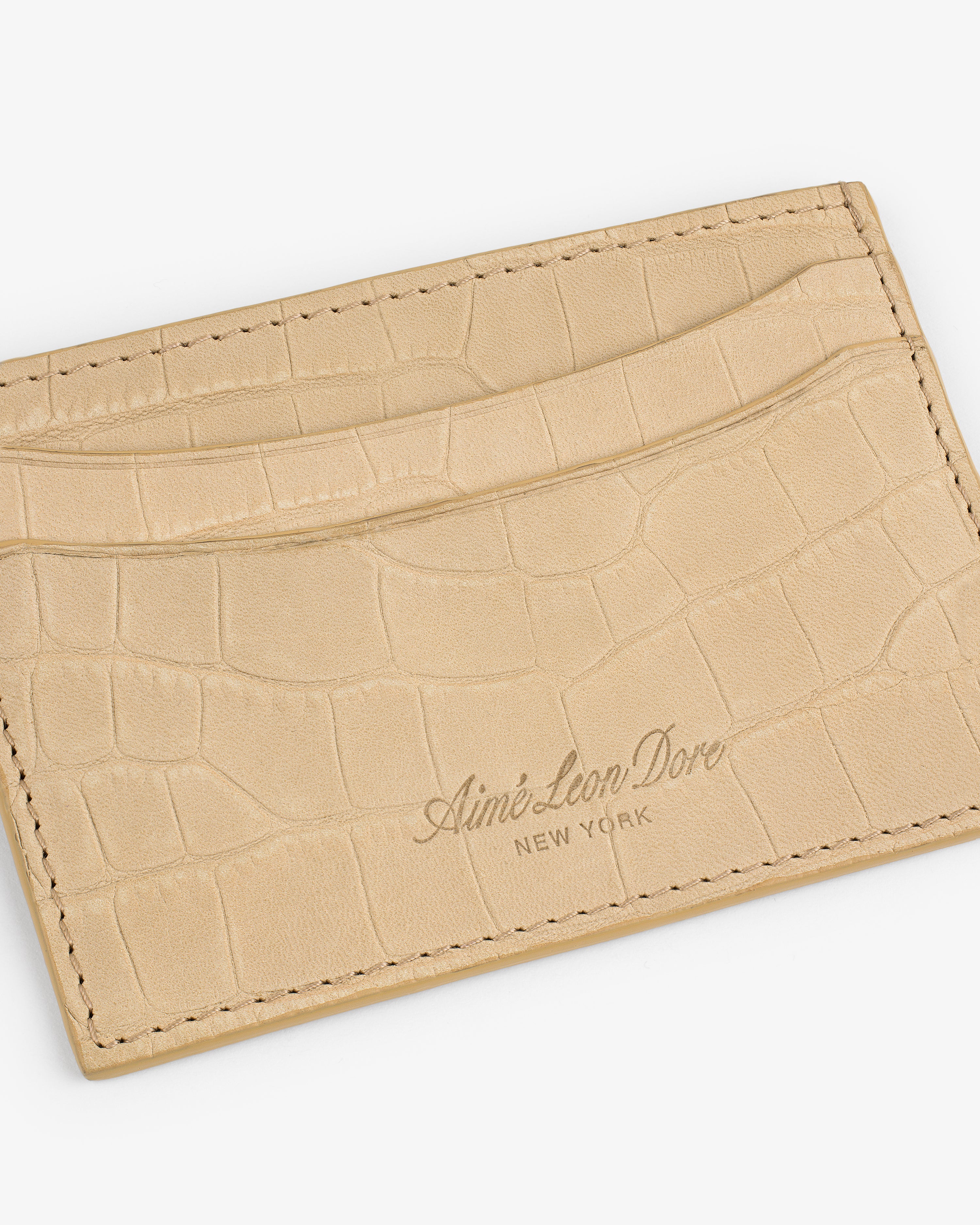 Croc-Embossed Nubuck Cardholder in beige with Aimé Leon Dore New York embossed on the front.