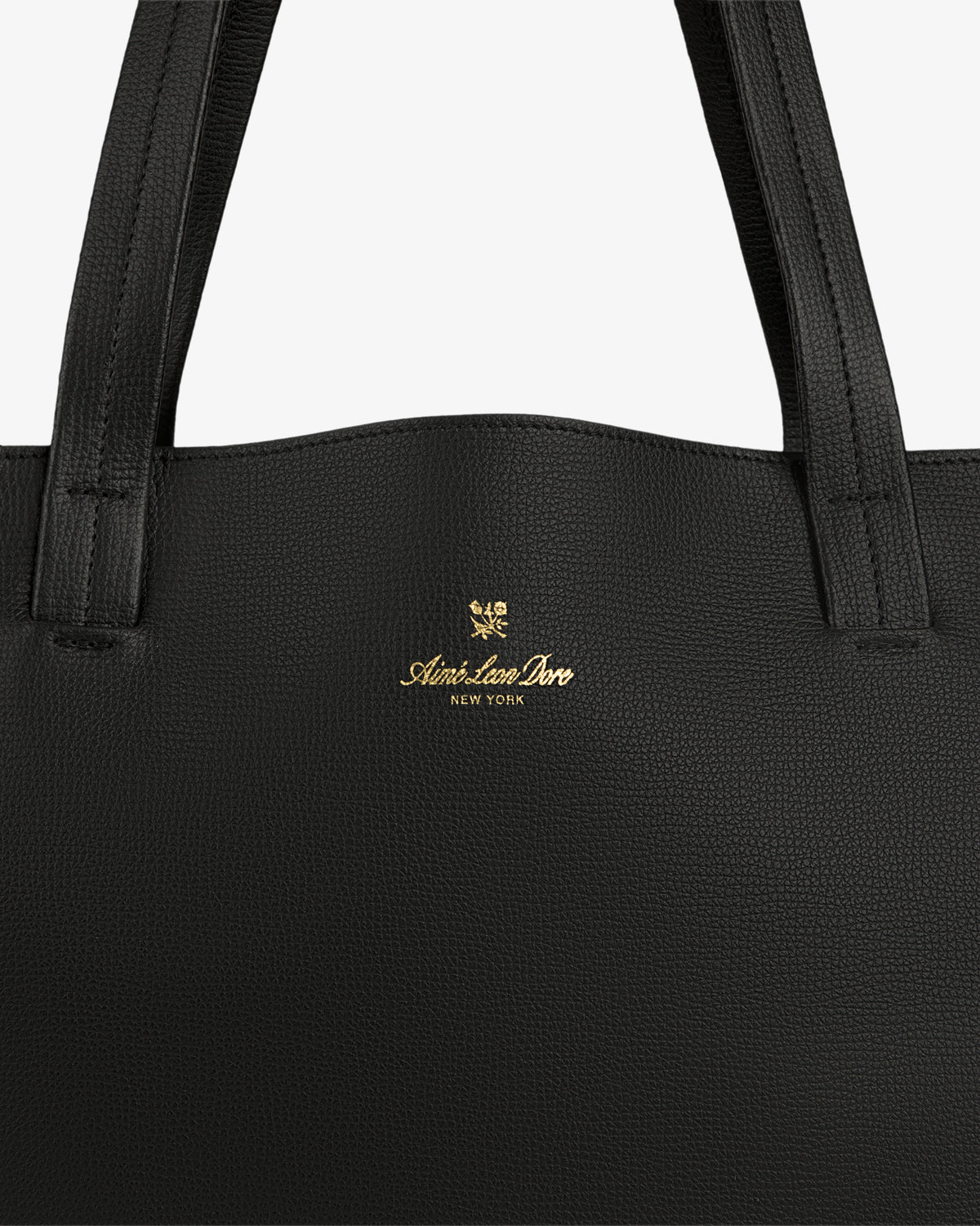 Close-up of a Full Grain Leather Tote Bag in black with Aimé Leon Dore New York and gold crest logo on the front.