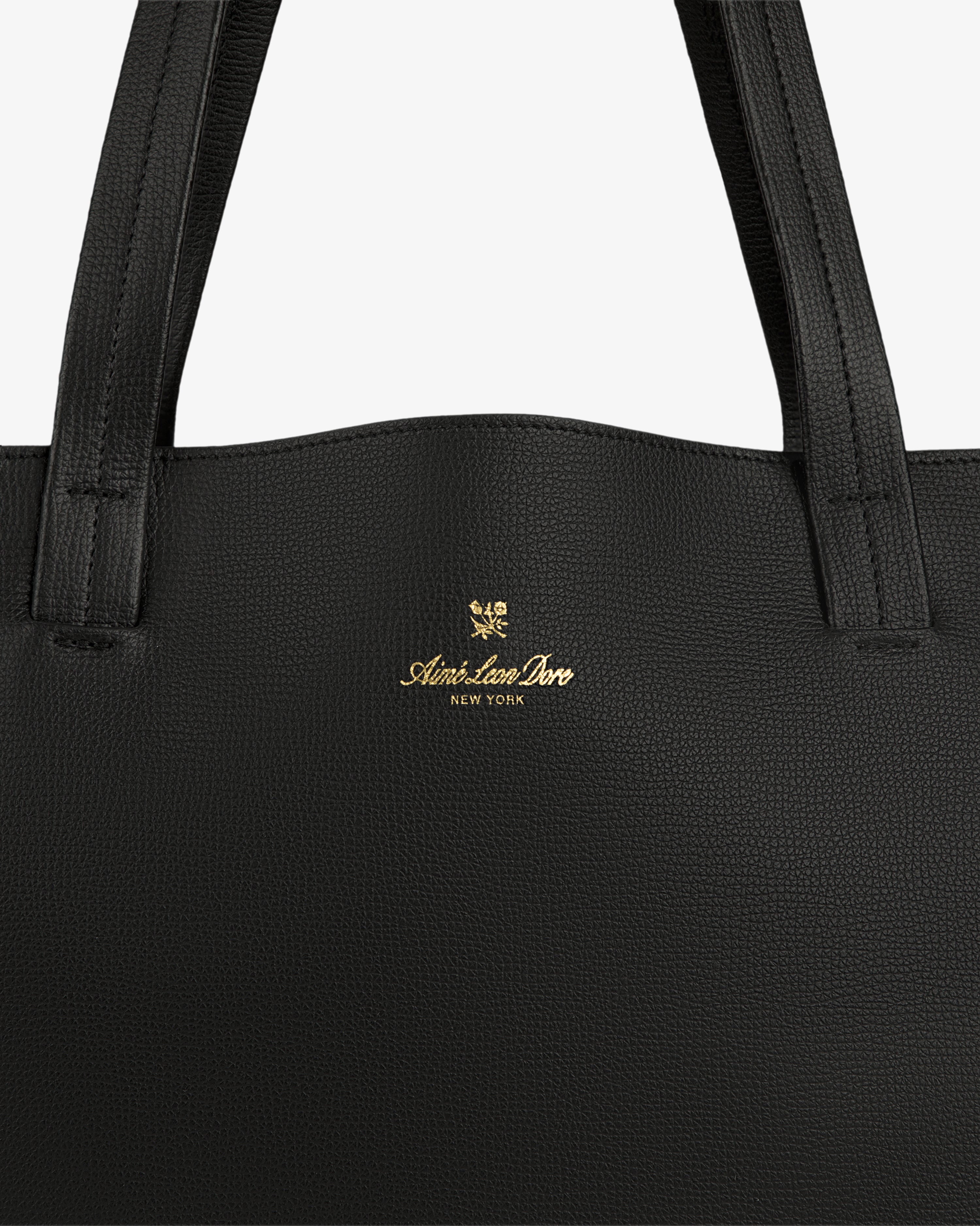 Close-up of a Full Grain Leather Tote Bag in black with Aimé Leon Dore New York and gold crest logo on the front.