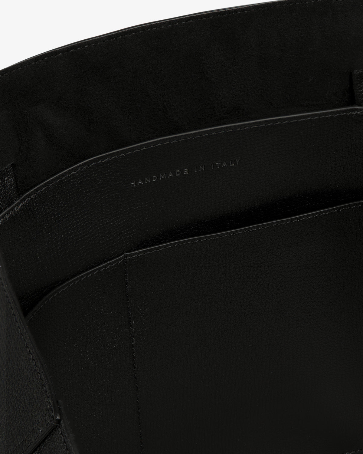 Close-up of Full Grain Leather Tote Bag’s interior with “Handmade in Italy” stamped in silver on the inner pocket.