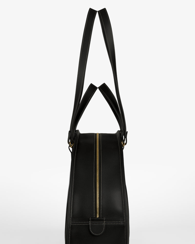 Full Grain Leather Weekender Bag in black, with gold zipper and double handles, shown side view on white background.
