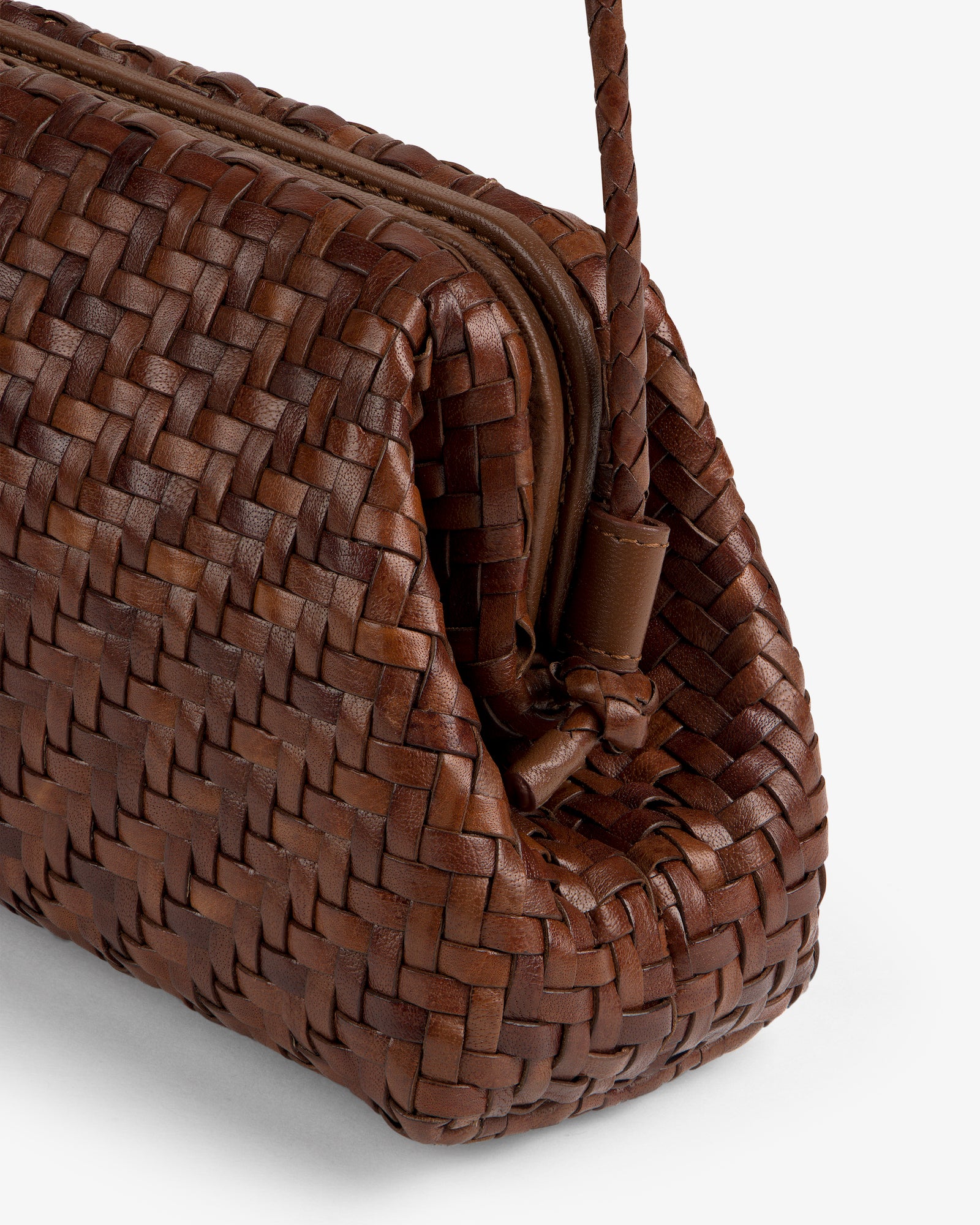 Close-up of the Woven Leather Shoulder Bag in brown, featuring a zipper and braided handle, on a white background.
