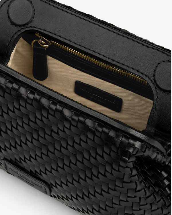 Close-up of the Woven Leather Shoulder Bag, open to show tan fabric lining and inner zippered pocket.