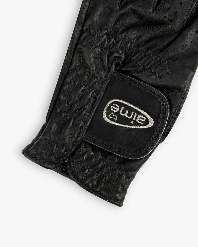Close-up of the ALD / FootJoy StaSof Heritage Glove (Left) in black leather with visible stitching and aimé velcro strap.