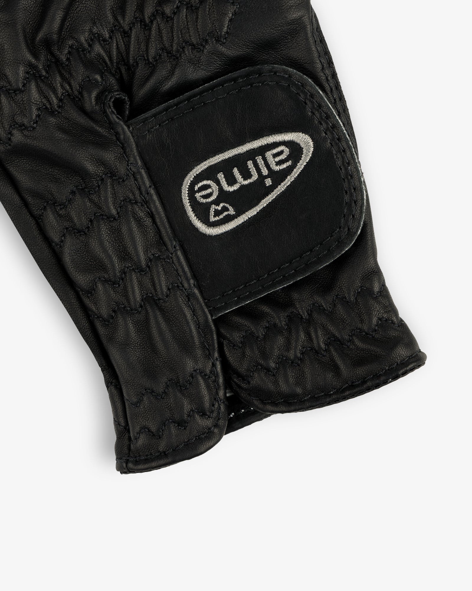 Black leather ALD / FootJoy StaSof Heritage Glove (Left) with visible stitching and a white aimé Velcro strap.