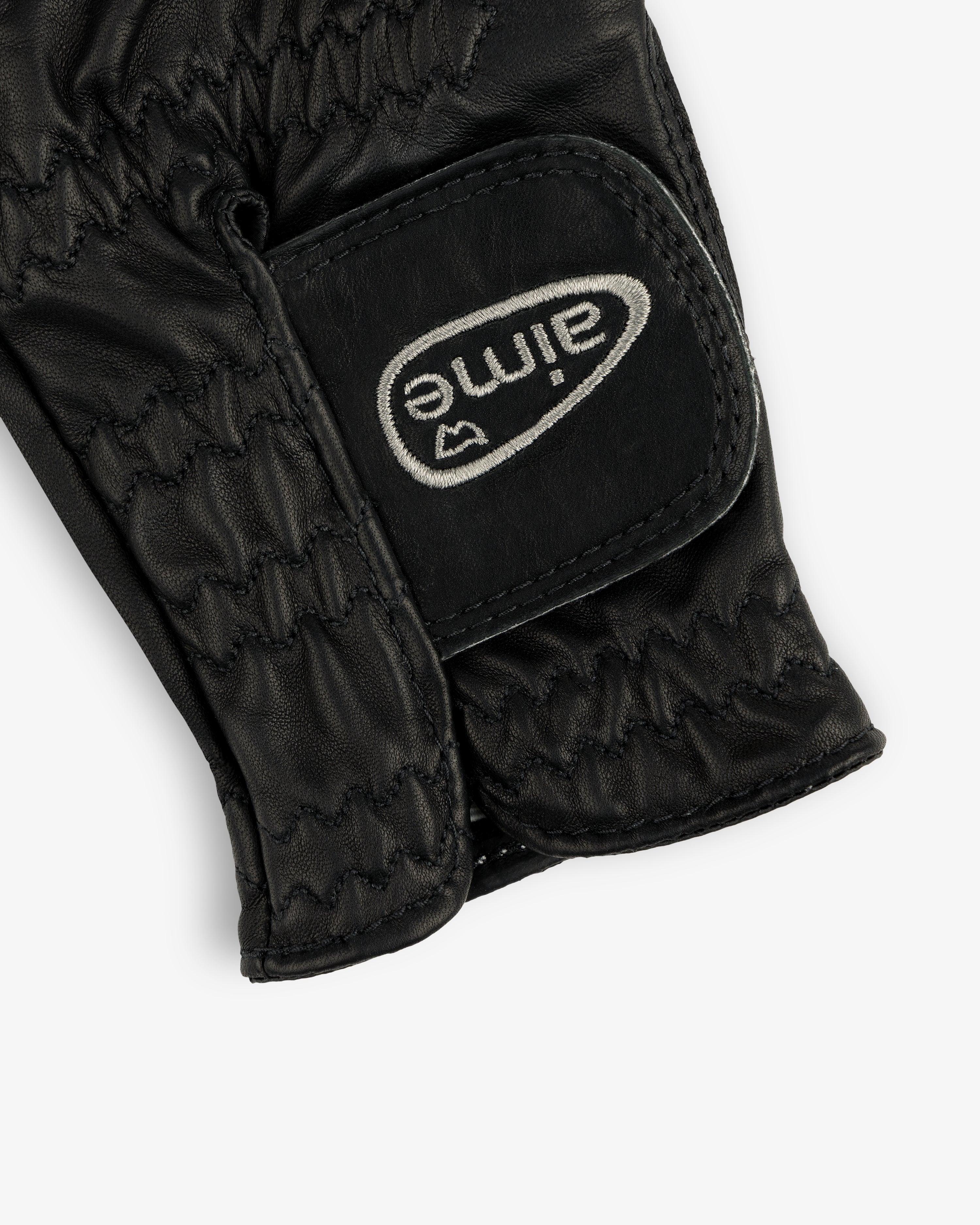 Black leather ALD / FootJoy StaSof Heritage Glove (Left) with visible stitching and a white aimé Velcro strap.