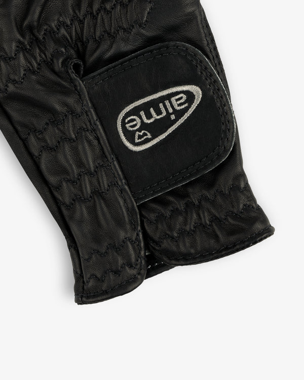 Black leather ALD / FootJoy StaSof Heritage Glove (Left) with visible stitching and a white aimé Velcro strap.