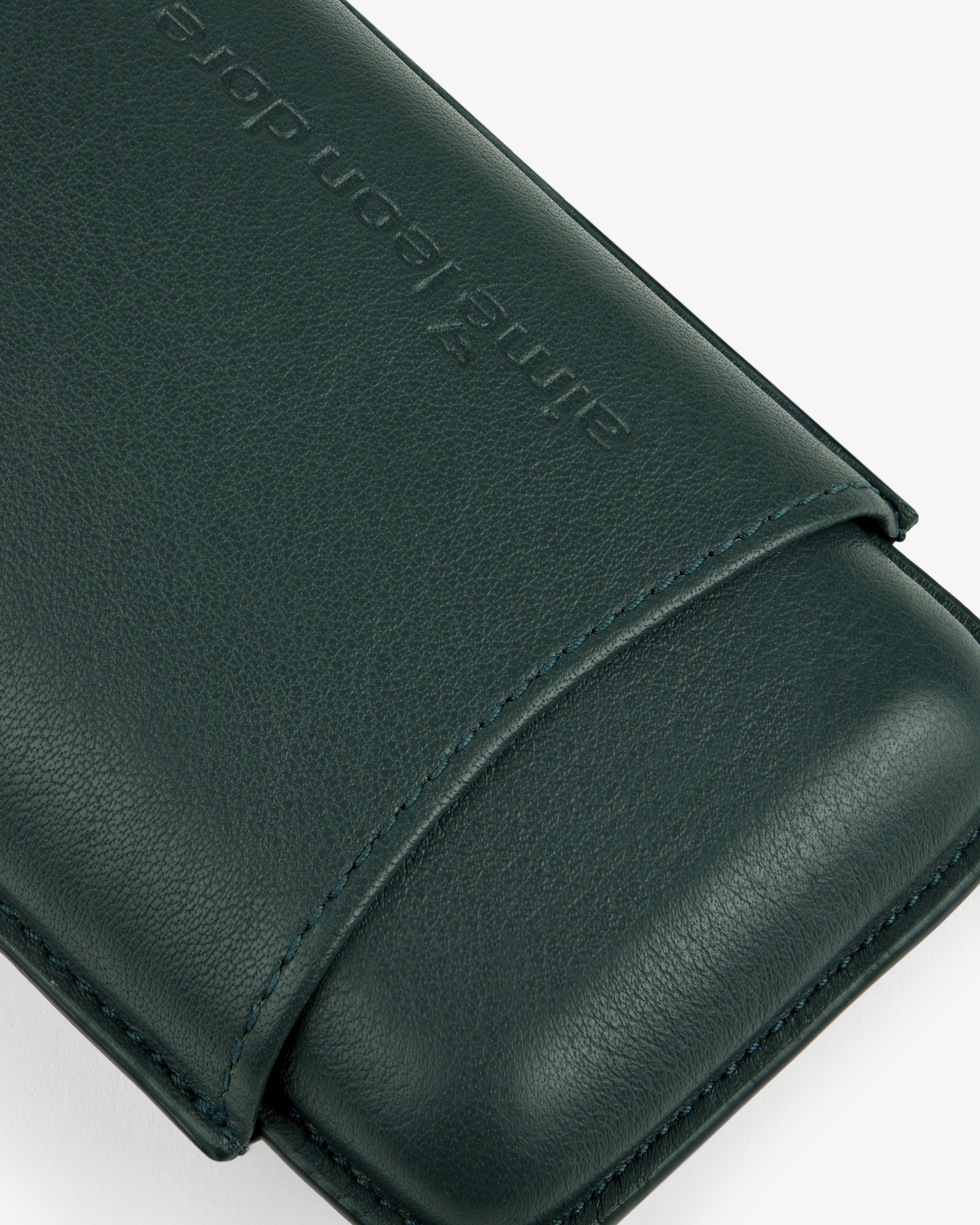 Close-up of the ALD Golf Leather Cigar Case in dark green, featuring embossed text against a light background.