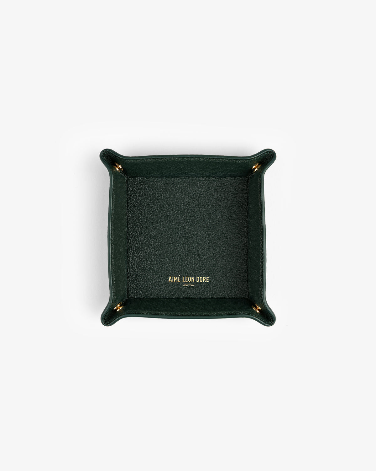 Dark green Leather Catchall with gold AIMÉ LEON DORE logo at center, photographed from above.
