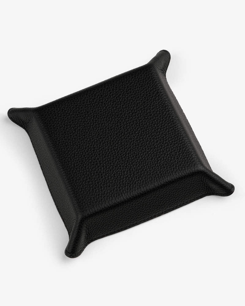 The Leather Catchall is a black leather valet tray with raised edges and pointed corners on a white background.