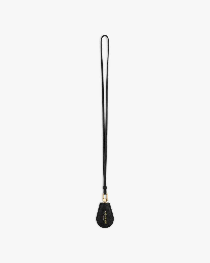Black Leather Key Cover by Louis Vuitton with gold hardware and wrist strap, shown on a white background.
