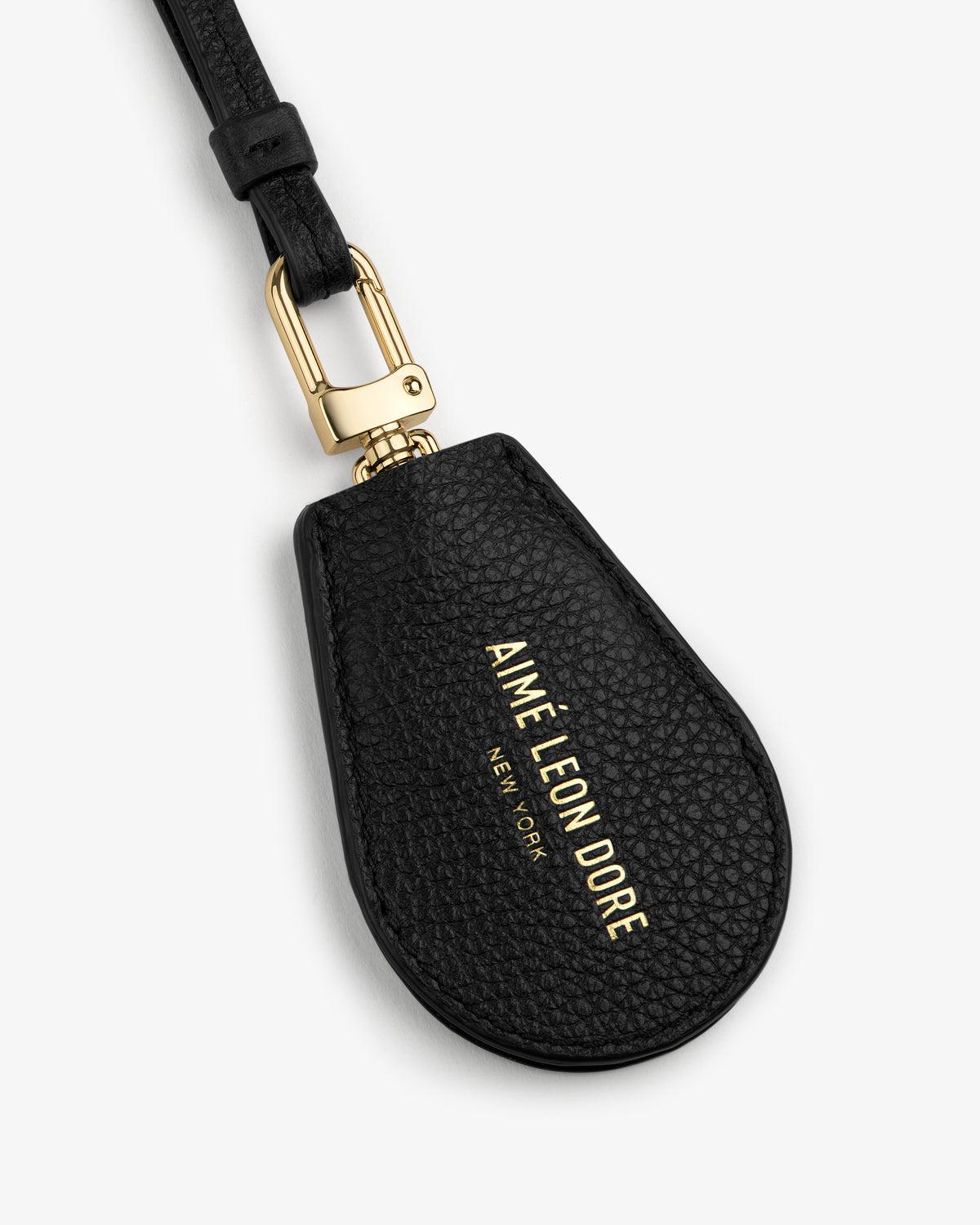 Black Leather Key Cover with gold hardware and AIMÉ LEON DORE NEW YORK embossed in gold letters.