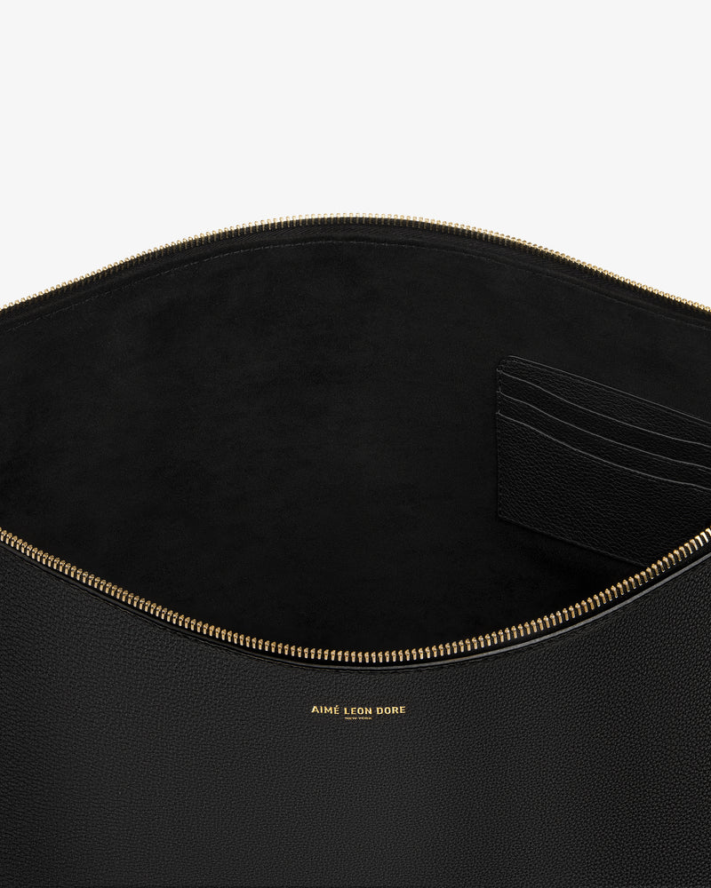 Large Leather Pouch in black leather with gold zipper, card slots, and gold AIME LEON DORE logo text inside.