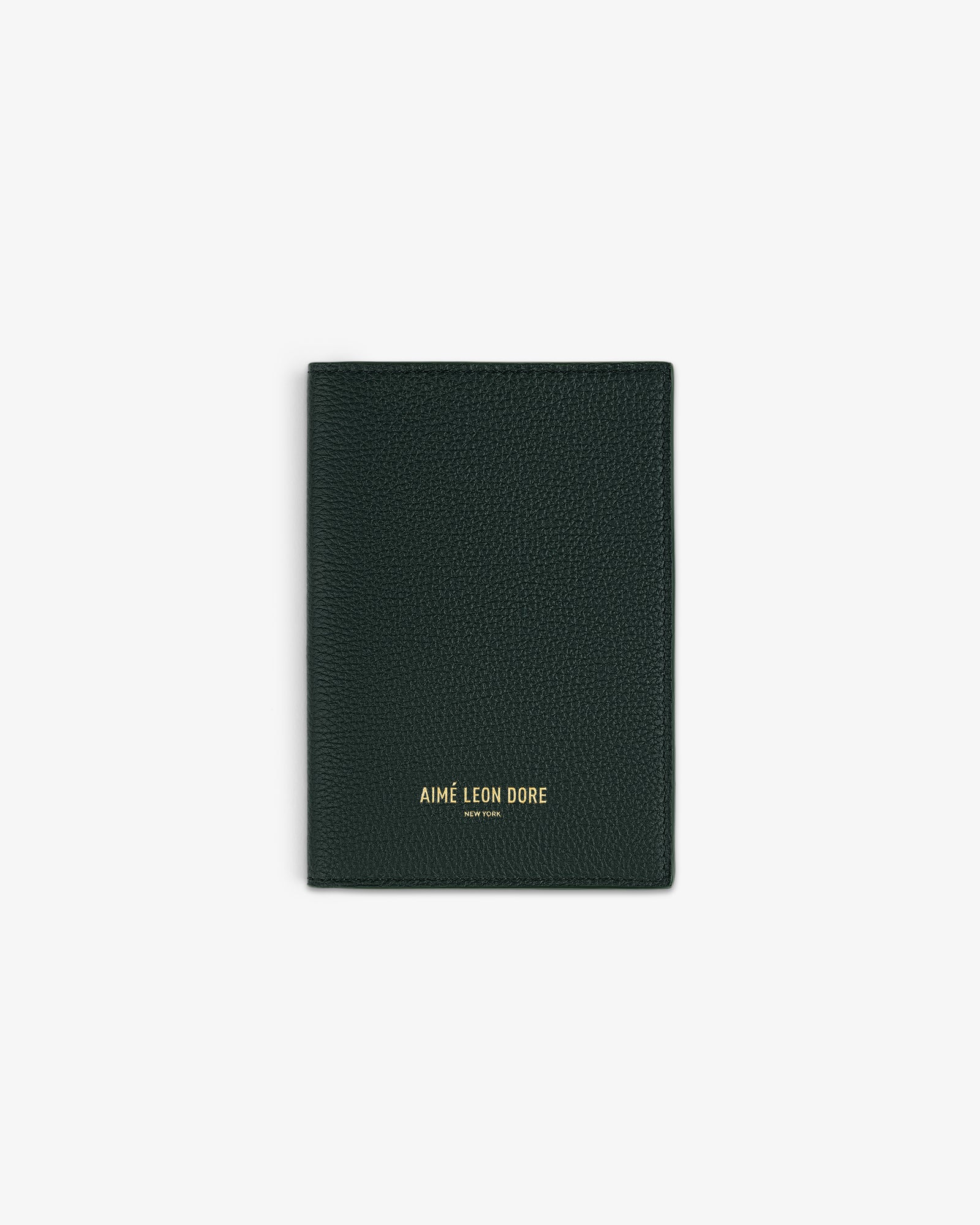 Dark green textured Leather Passport Holder with AIMÉ LEON DORE gold lettering on the front.