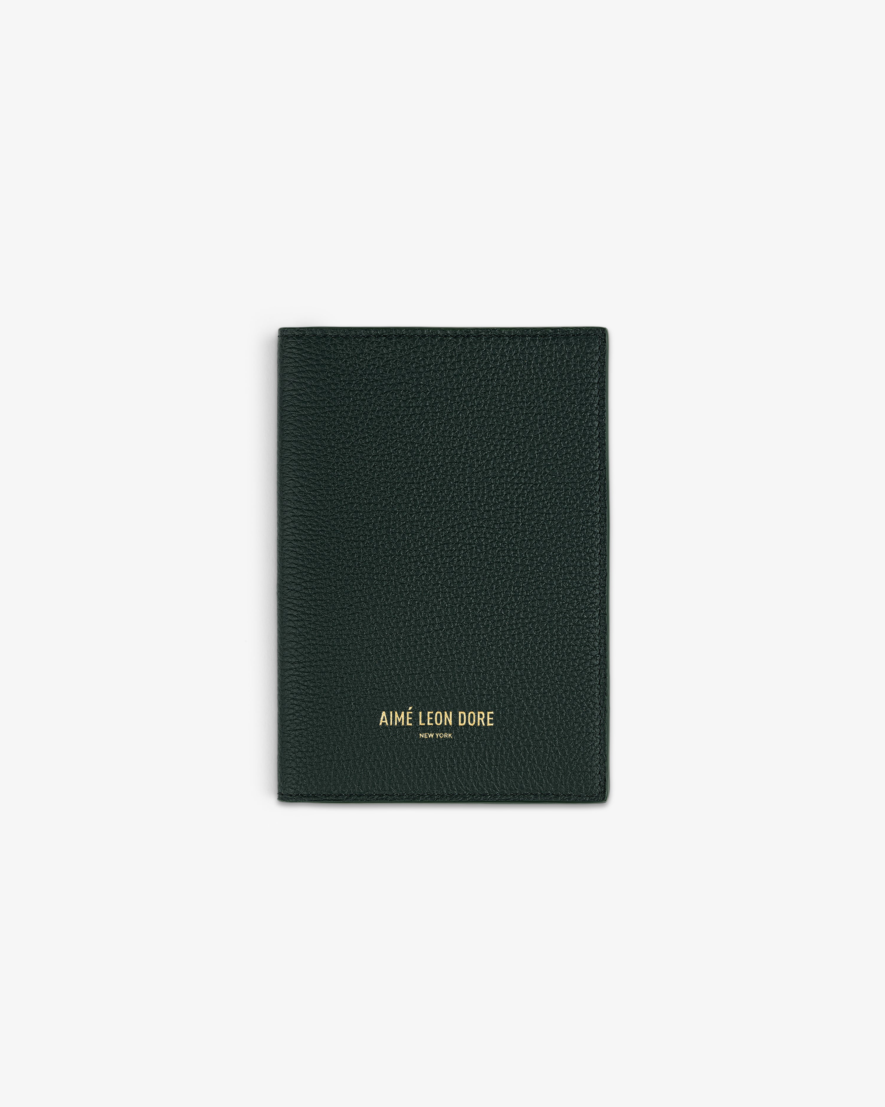 Dark green textured Leather Passport Holder with AIMÉ LEON DORE gold lettering on the front.