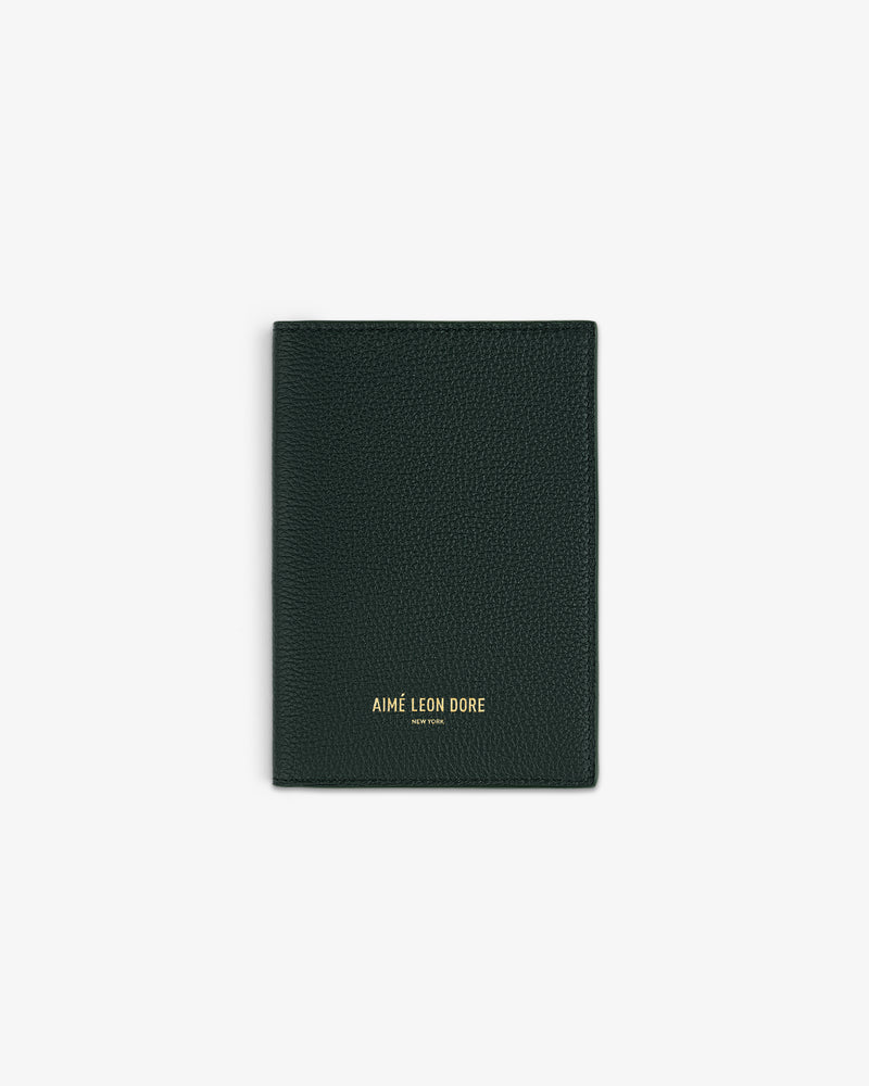 Dark green textured Leather Passport Holder with AIMÉ LEON DORE gold lettering on the front.