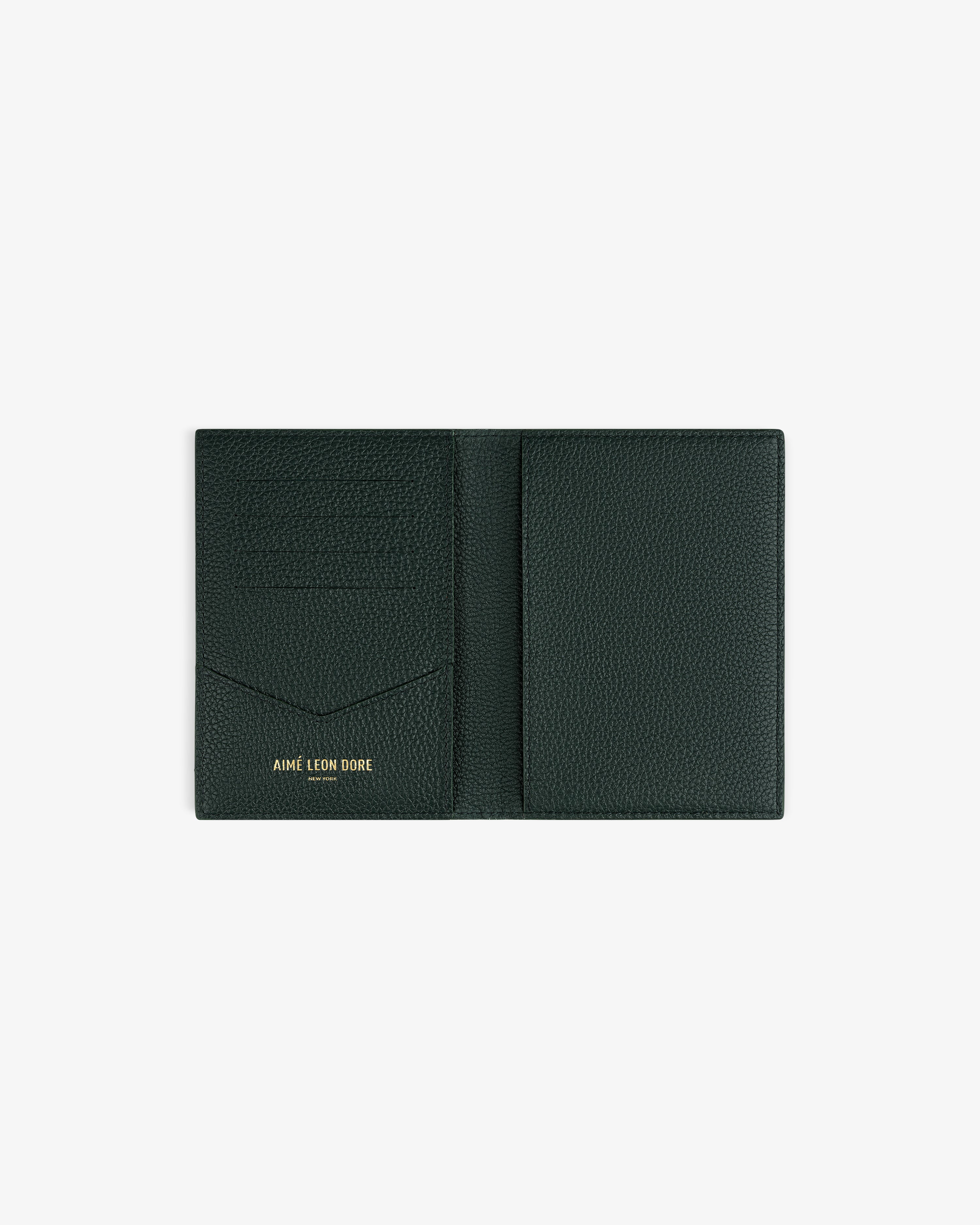 Open dark green Leather Passport Holder with “AIME LEON DORE” in gold on the left pocket, on white background.