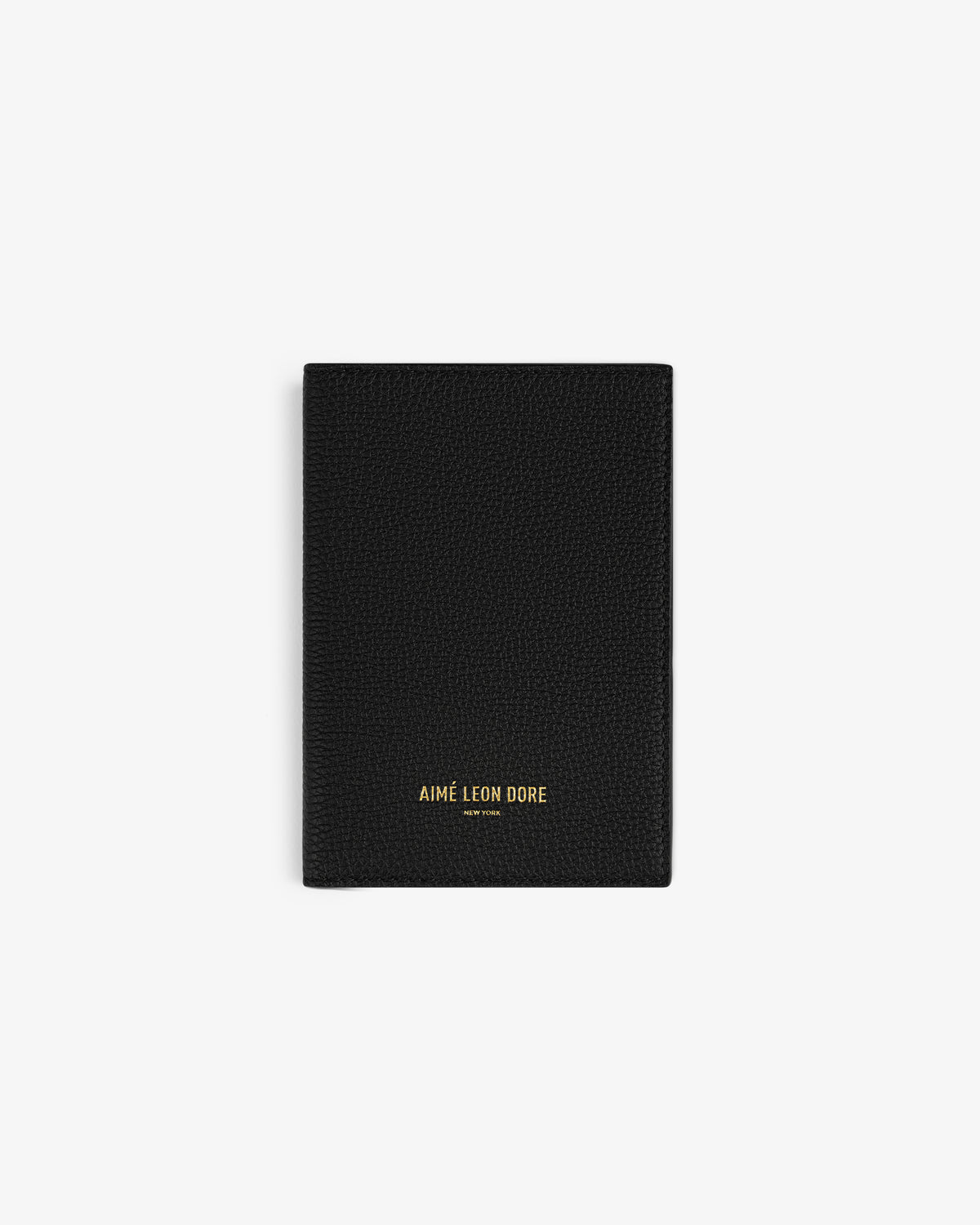 A black Leather Passport Holder with AIMÉ LEON DORE in gold at the bottom center.