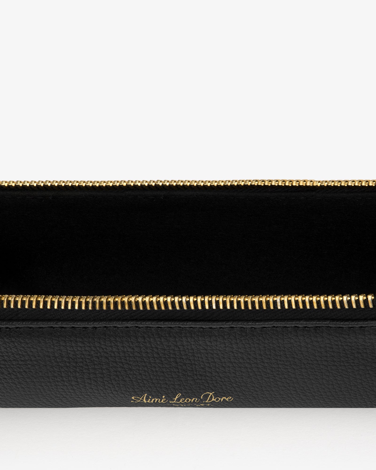 Black Leather Pencil Case with gold Aimé Leon Dore branding and zipper, shown on a white background.