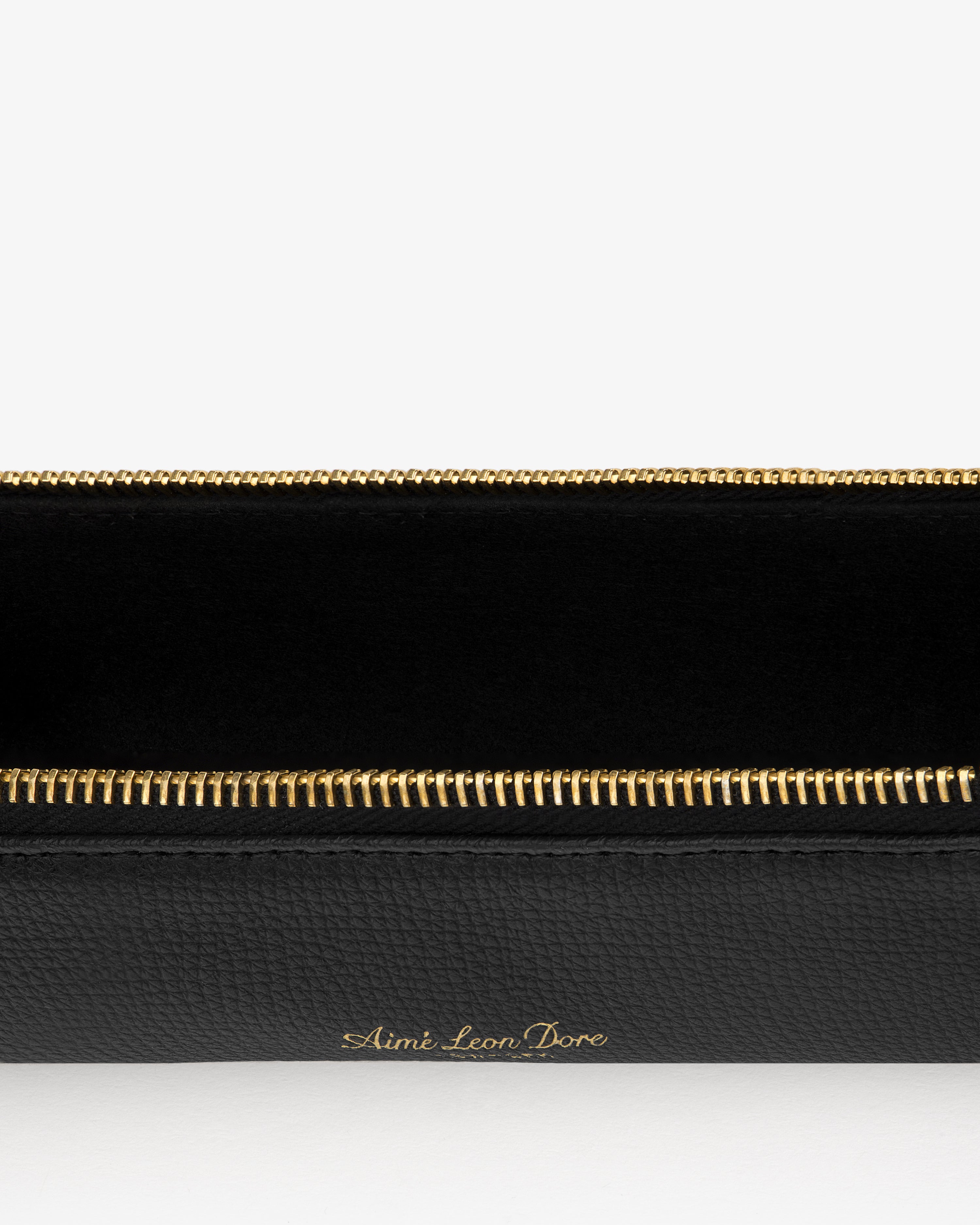 Black Leather Pencil Case with gold Aimé Leon Dore branding and zipper, shown on a white background.