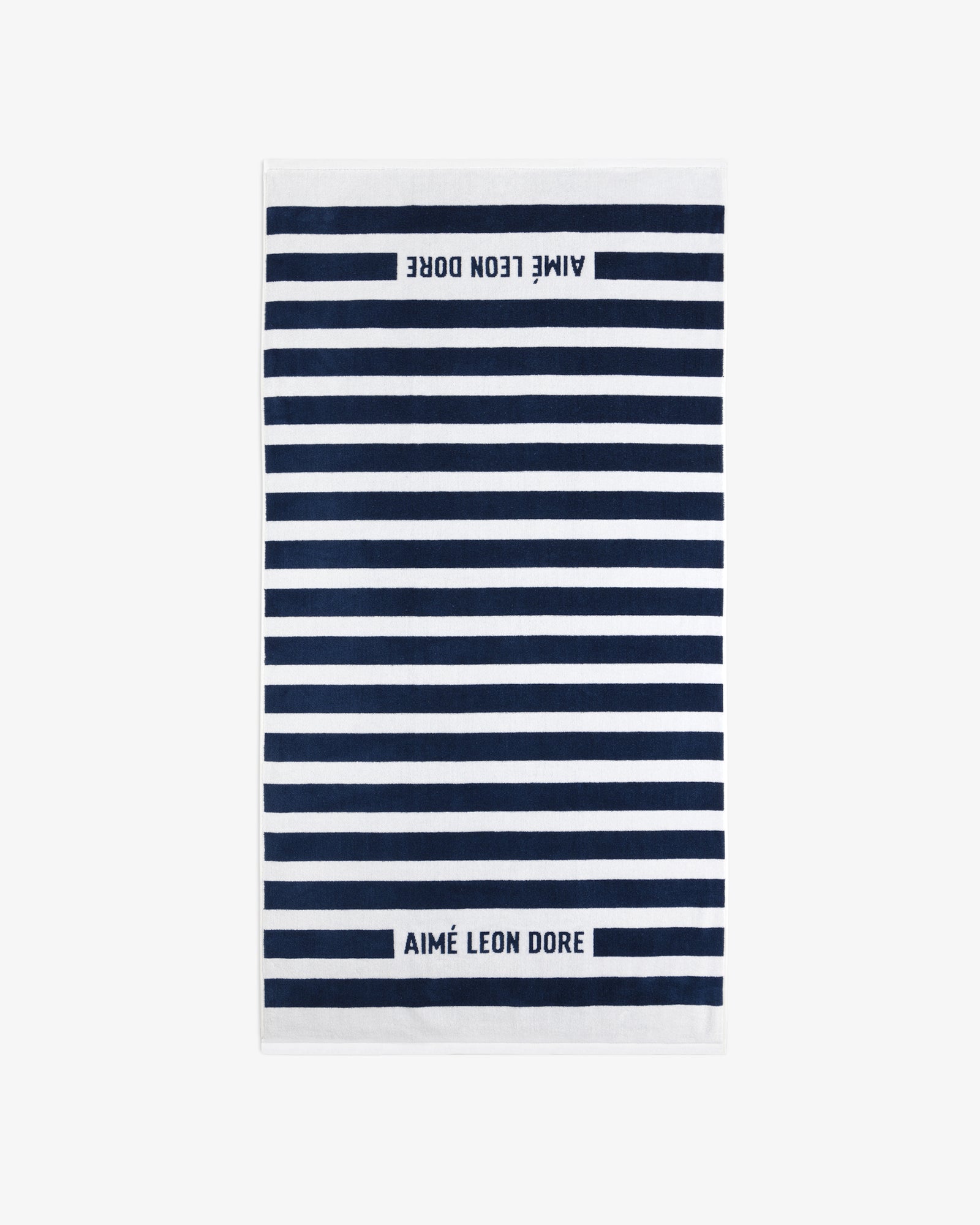Striped Beach Towel in navy and white with AIMÉ LEON DORE text at both ends.