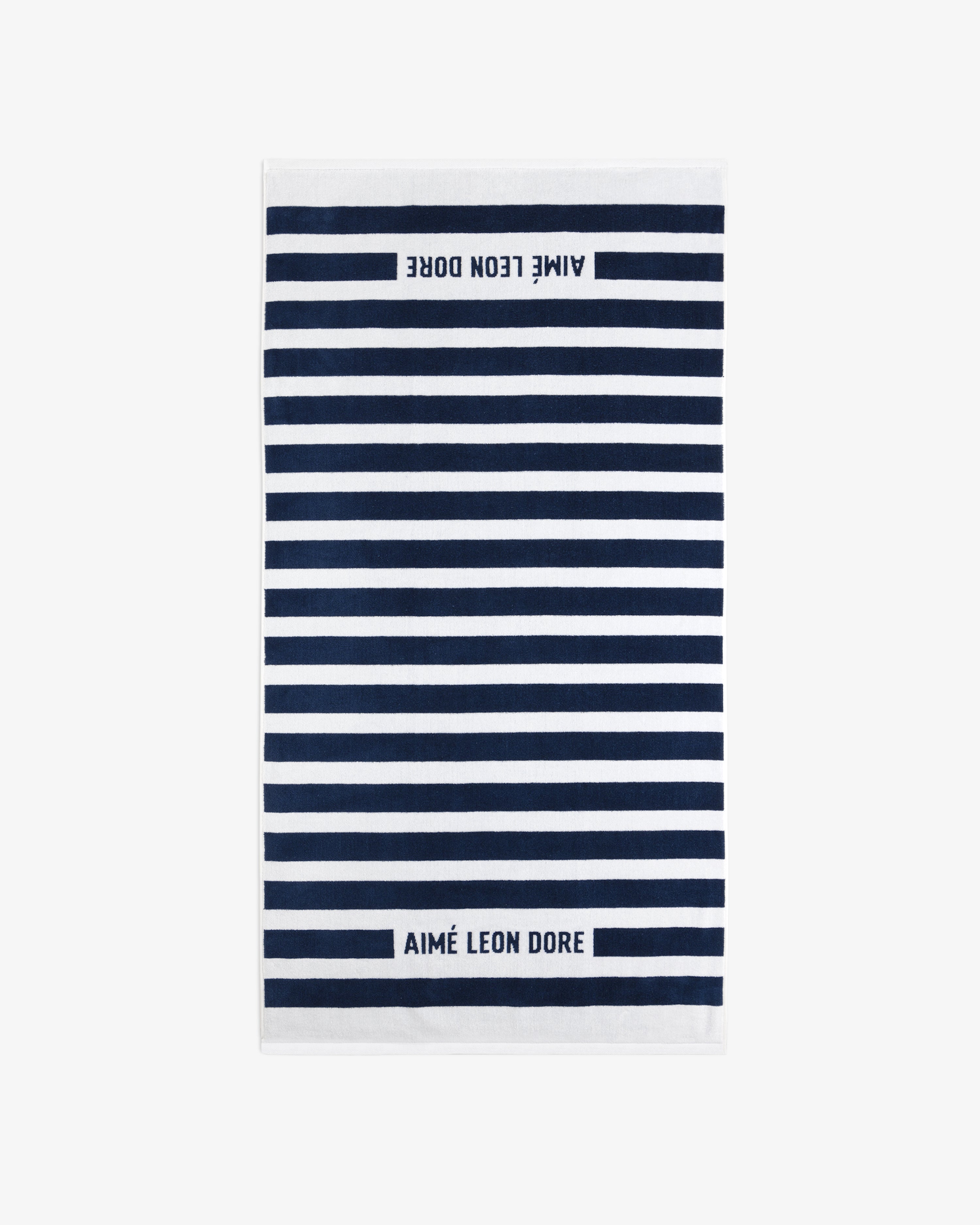 Striped Beach Towel in navy and white with AIMÉ LEON DORE text at both ends.