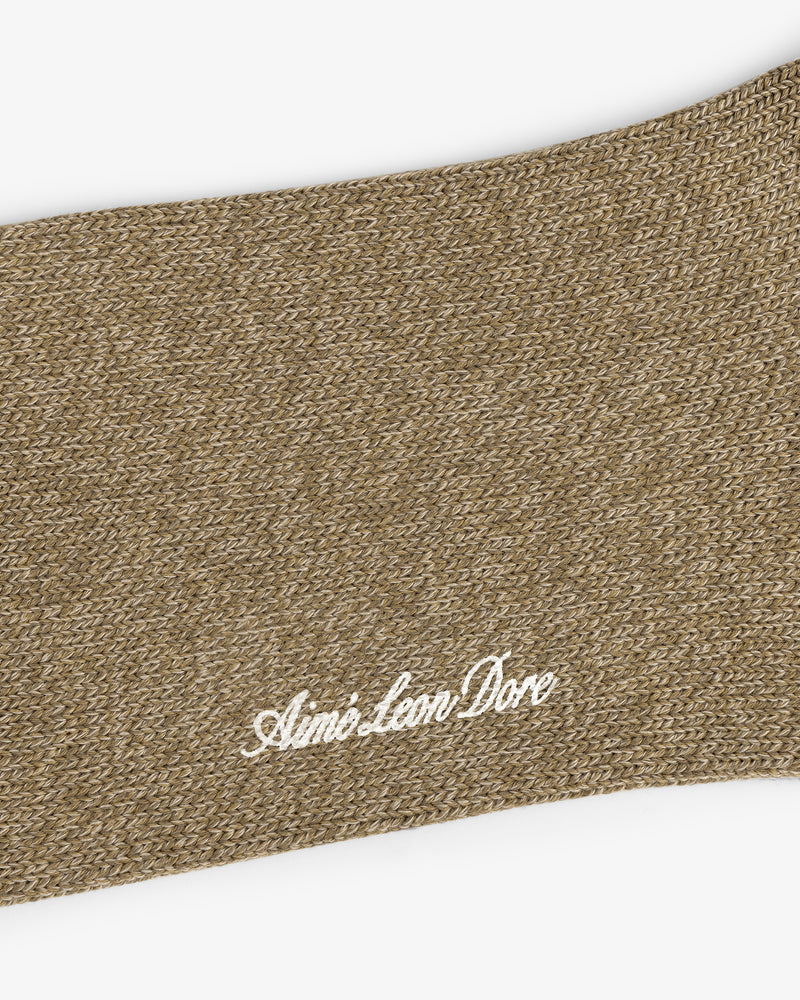 Close-up of brown knit Marled Quarter Sock with Aimé Leon Dore embroidered in white cursive.