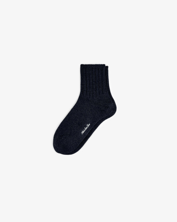 A single Marled Quarter Sock, black and ribbed with white sole text, shown on a plain white background.