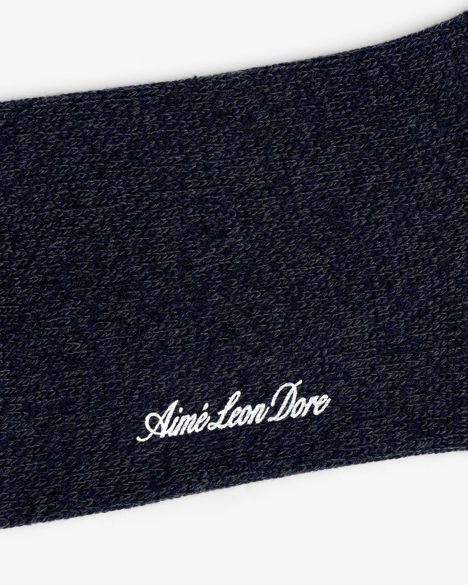 Close-up of Marled Quarter Sock knit with "Aime Leon Dore" embroidered in white cursive.