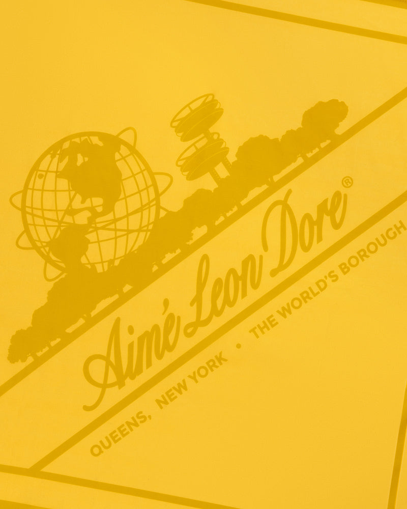 Sun Faded Unisphere Bandana: yellow graphic with Aimé Leon Dore, globe, trees, and Queens, New York text.