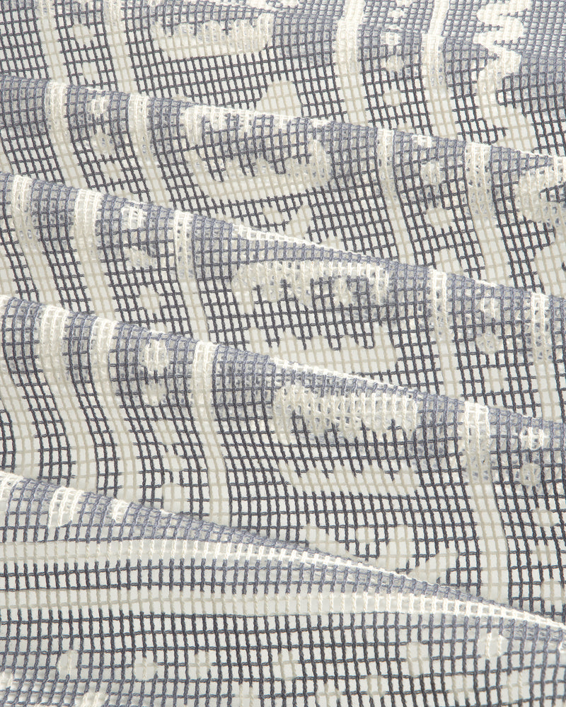 Close-up of the Mesh Tapestry Bandana featuring a geometric grid and wavy white and gray patterns.