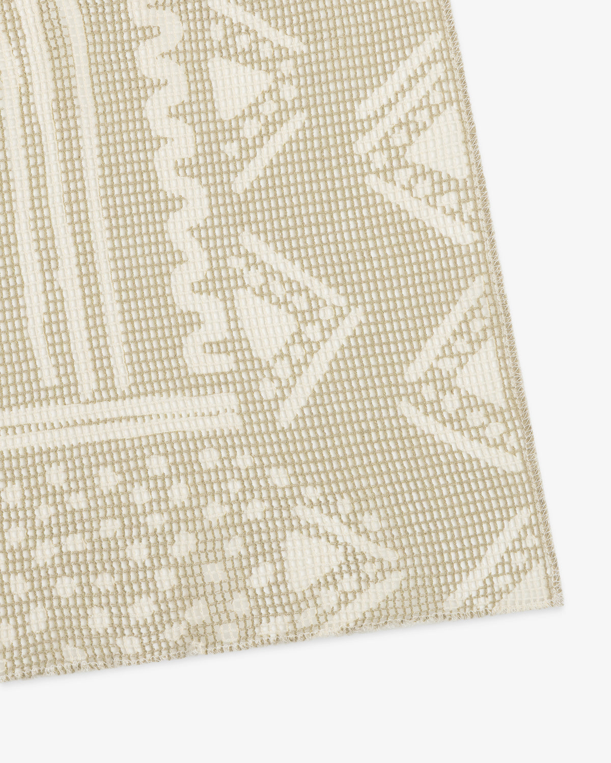 Close-up of a Mesh Tapestry Bandana in beige and white with geometric and zigzag patterns.