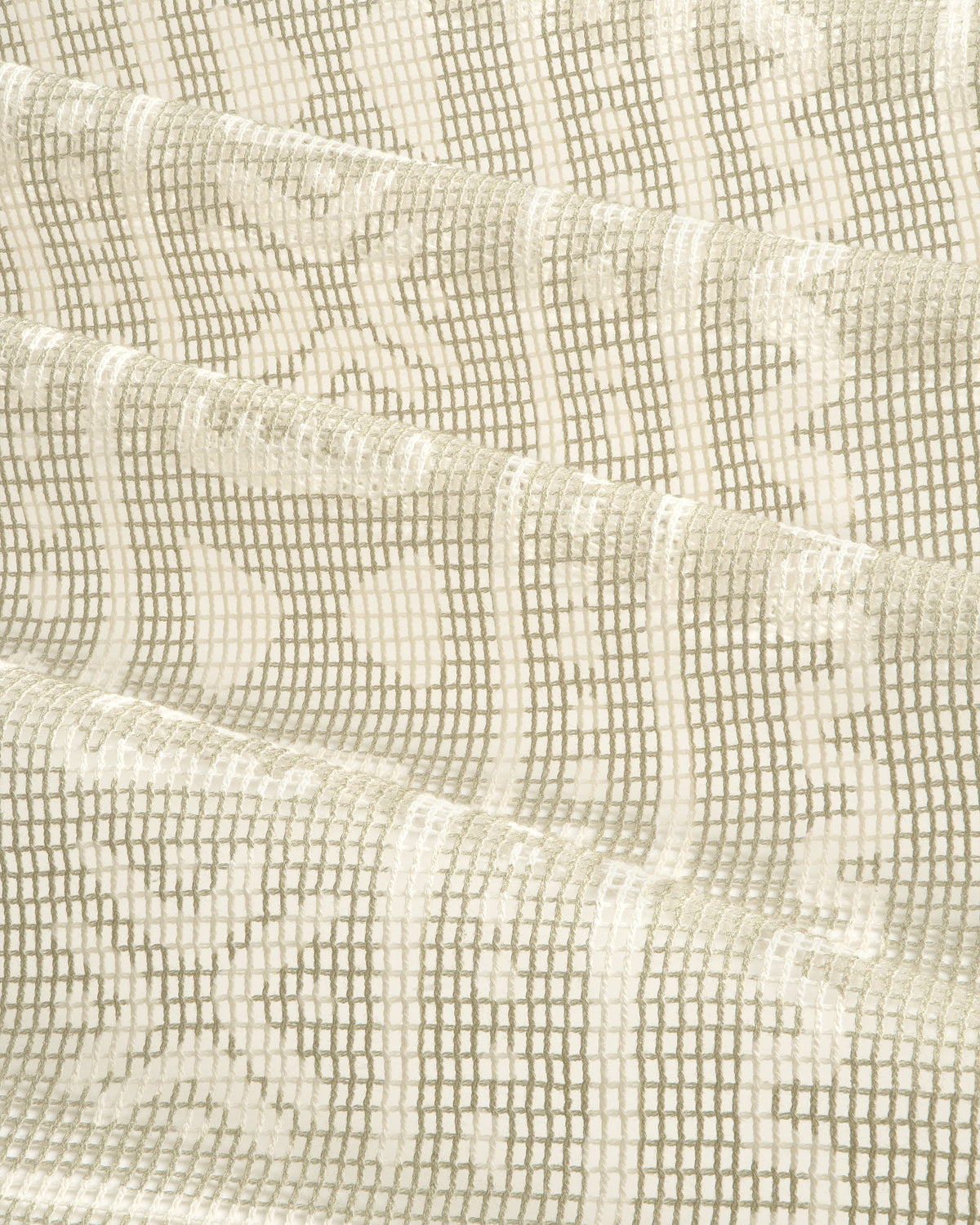 Close-up of the Mesh Tapestry Bandana in cream, showing its textured grid and floral pattern, softly folded.