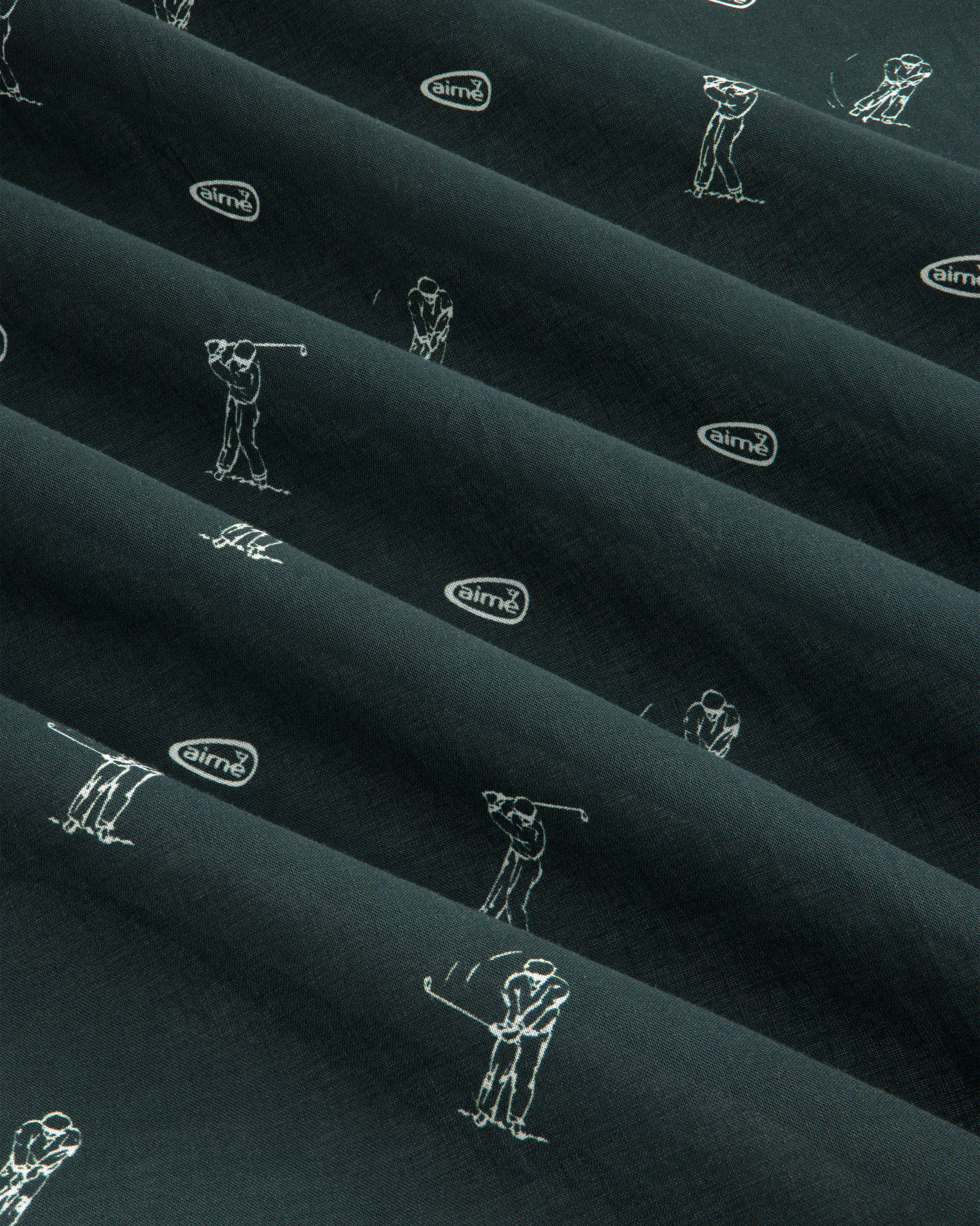 The ALD Golf Swing Bandana features dark fabric with white golfer sketches and airmx logos arranged diagonally.