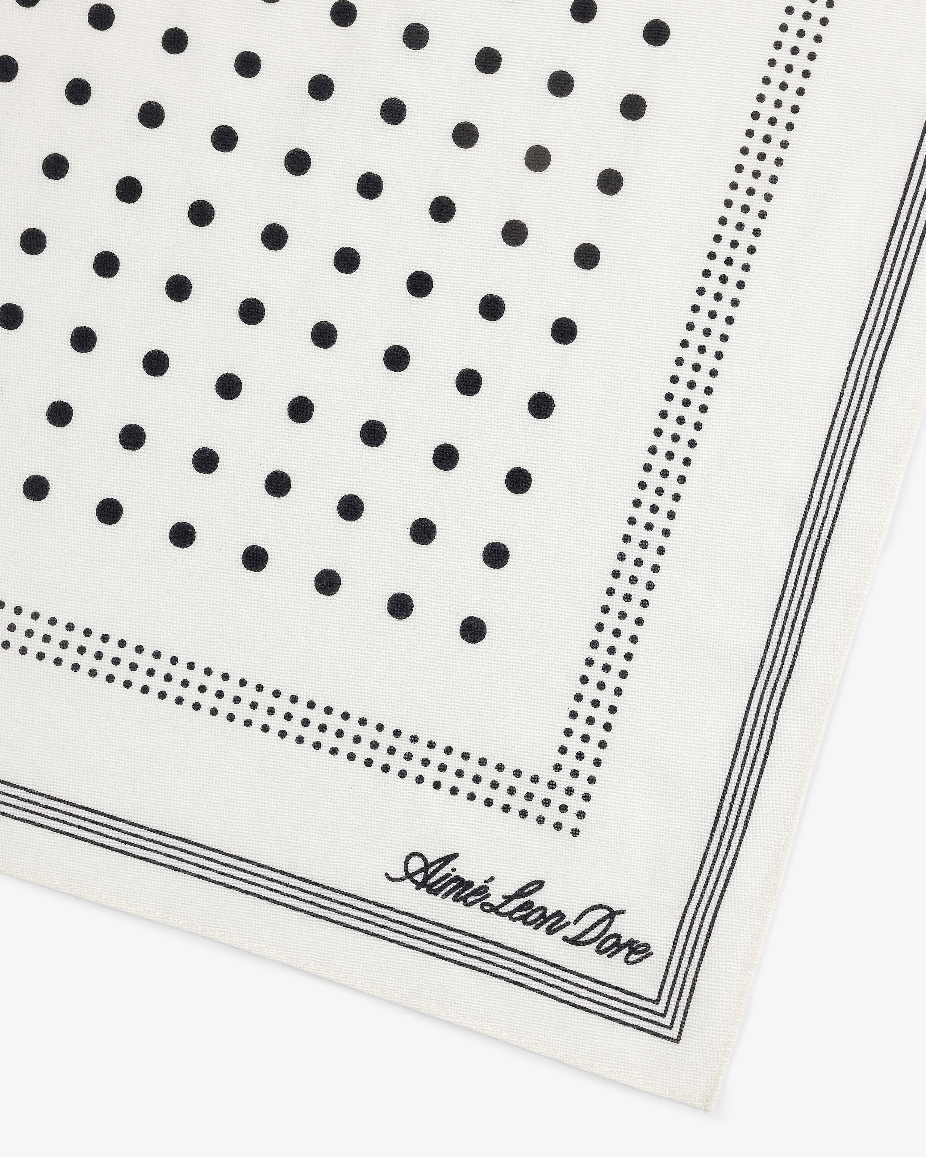 Polka Dot Bandana: white with black polka dots, dotted borders, and Aimé Leon Dore script in the corner.